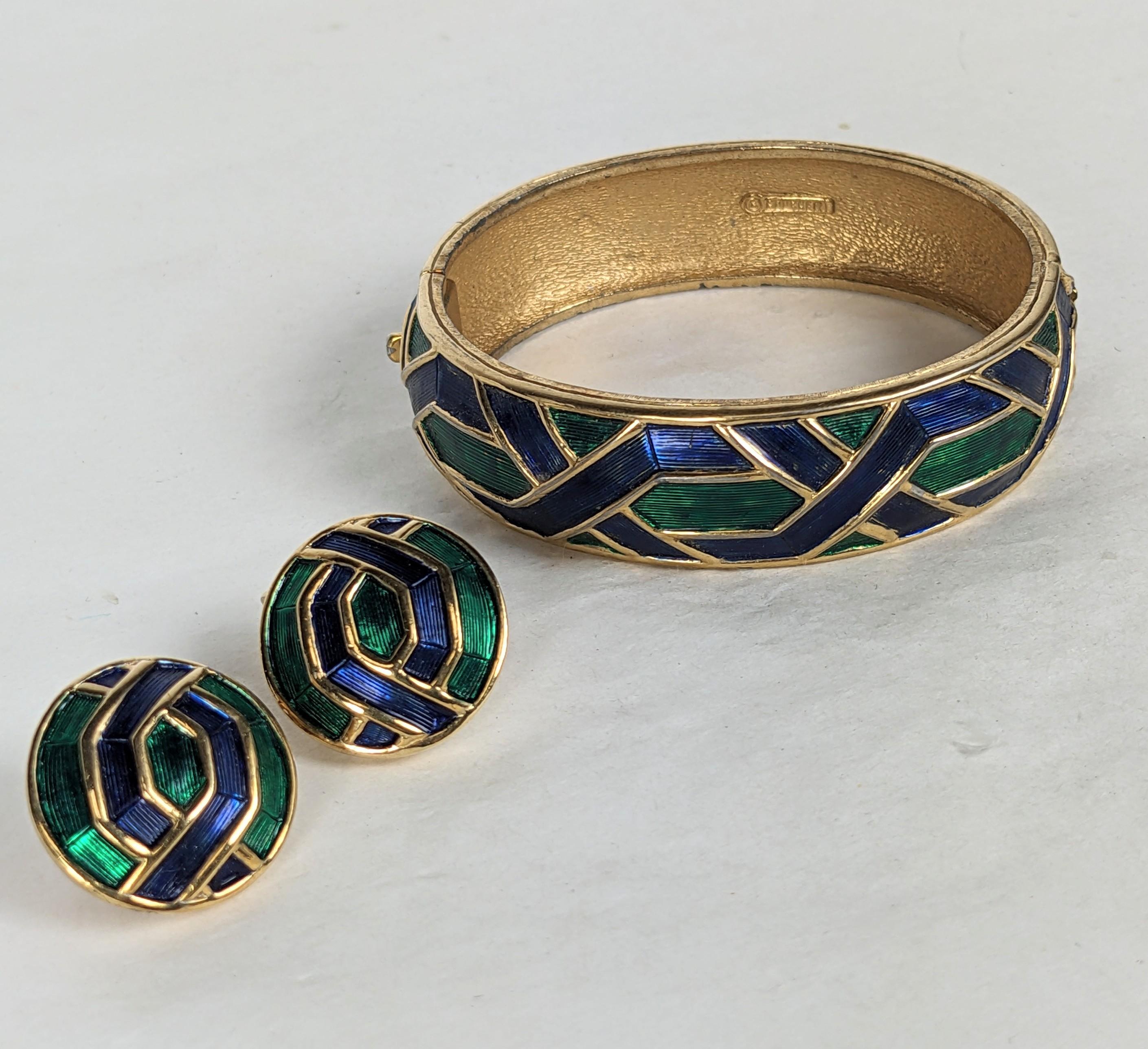 Marcel Boucher Enamel Bangle Suite from the 1960's. Bangle and matching ear clip earrings. Gilt metal with emerald and deep sapphire glowing enamel in geometric motifs. 1960's USA. 
Bracelet .65