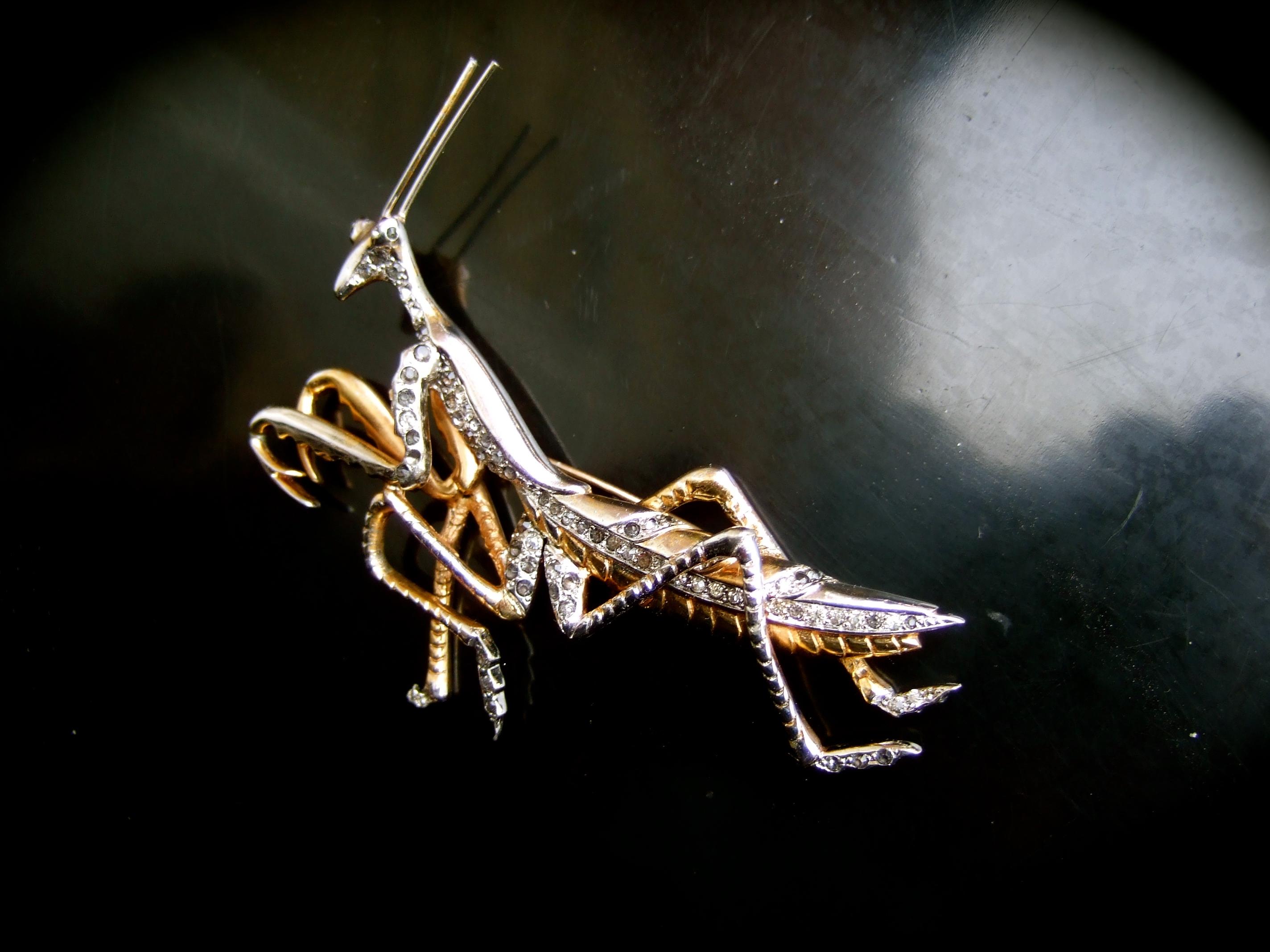 Marcel Boucher Extremely rare art deco praying mantis costume insect brooch c 1941
The rare avant-garde 1940s figural brooch is designed with a stylized praying mantis insect
Adorned with metal rod antennas on top of the head

The legs & body are