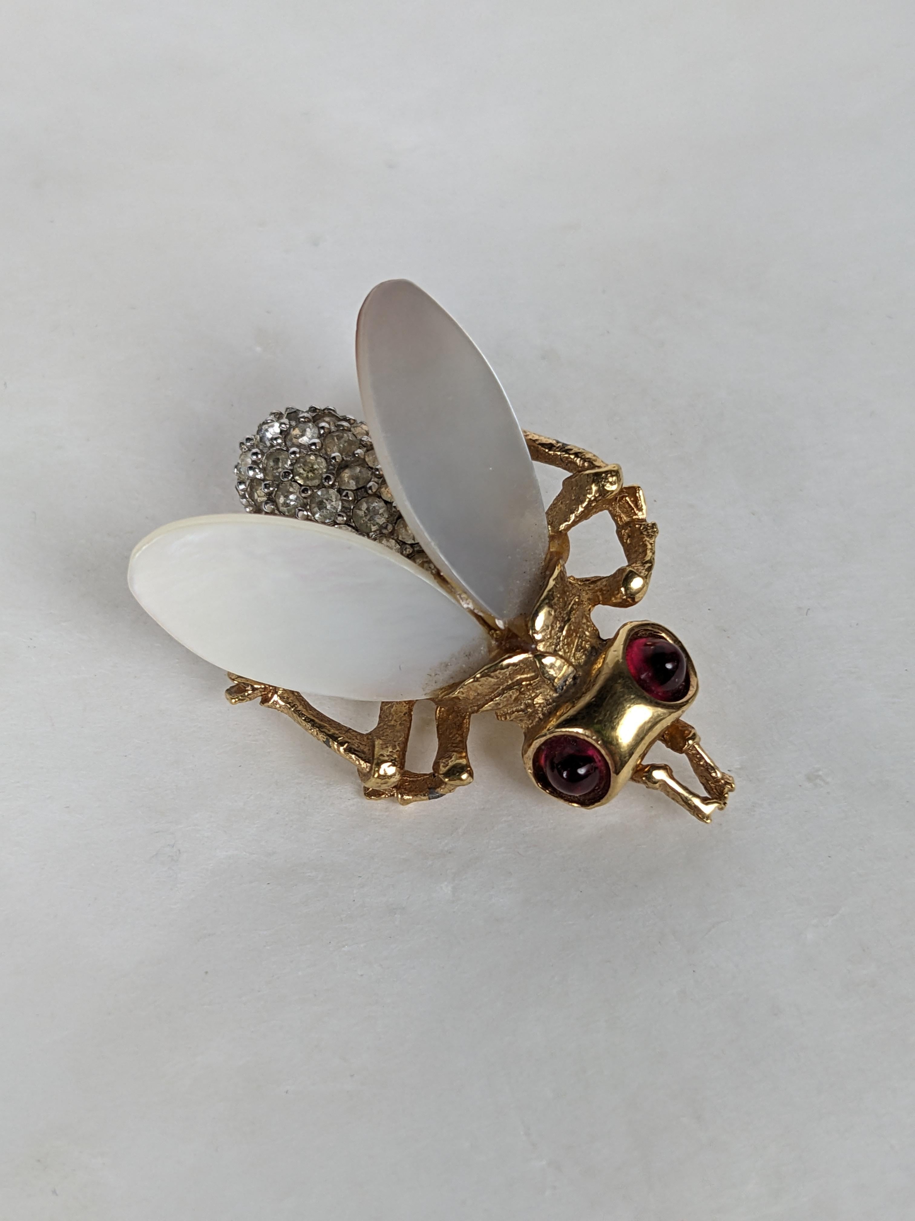 Charming Marcel Boucher Mother of Pearl Pave Bee from the 1960's. Wonderfully detailed with pave crystal body, mother of pearl wings and faux ruby cab eyes. 1.5 x 1