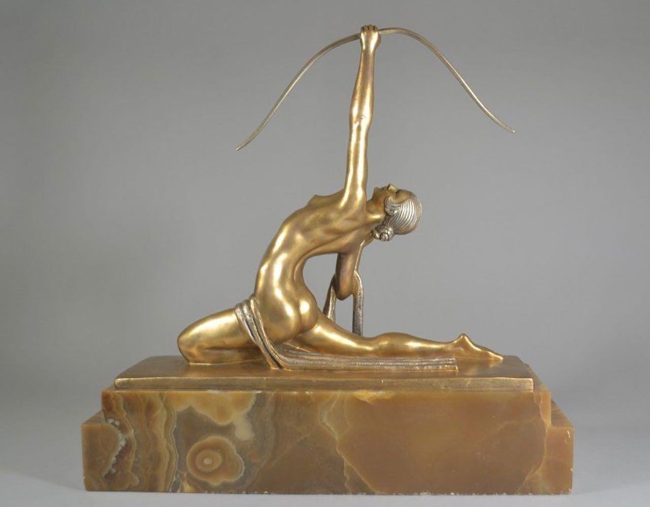 This stunning bronze sculpture portrays Diana the Huntress, the Roman goddess of the hunt, on a large onyx marble base. The sculpture was crafted by the renowned French artist Marcel Bouraine in the 1930s, making it a rare and valuable piece of