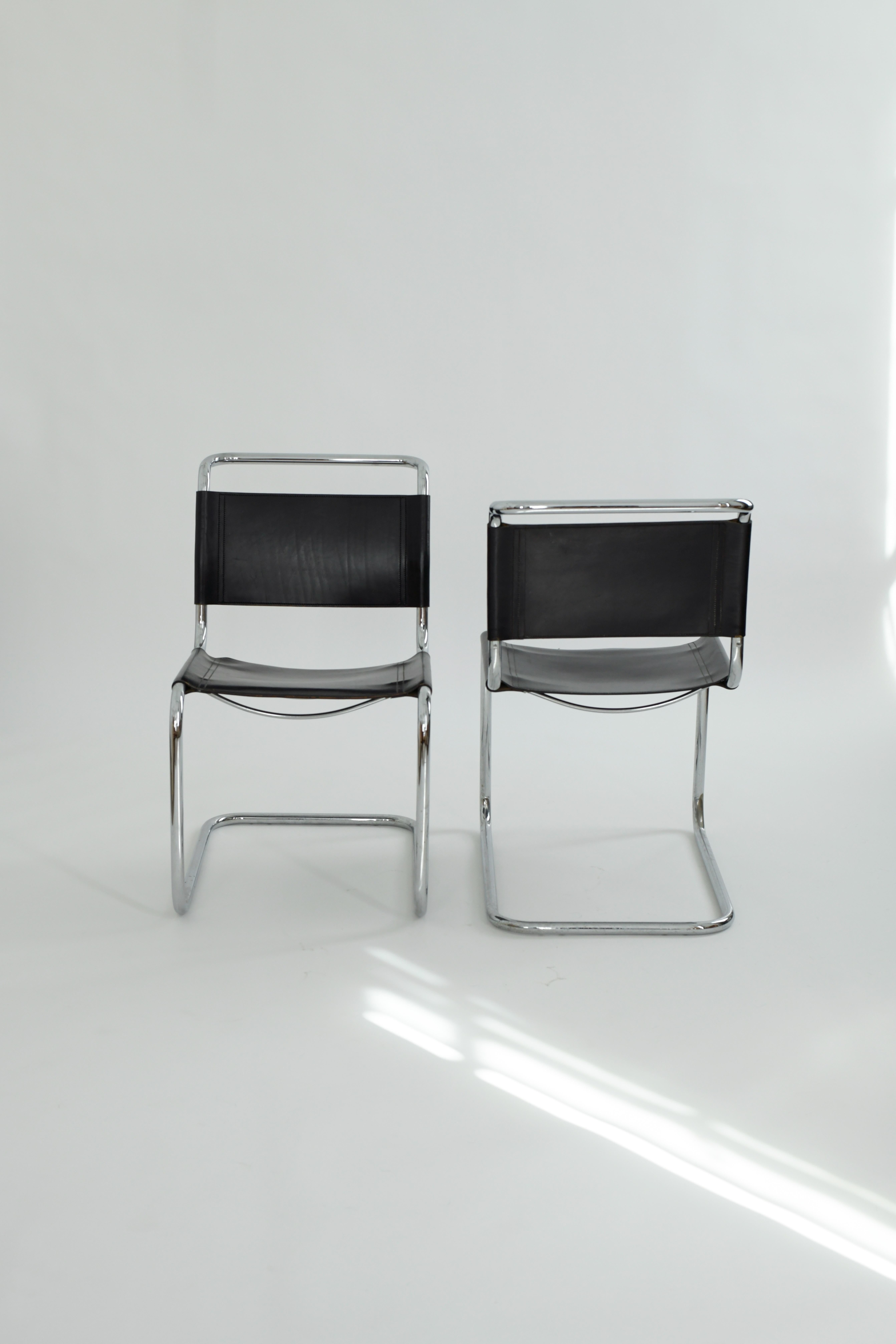 1970s pair of S33 dining chairs by Mart Stam for Fasem, Italy. These iconic bauhaus chairs have beautiful patinated leather seats and backs and are incredibly comfortable due to the cantilevered tubular steel design. This pair is in good vintage