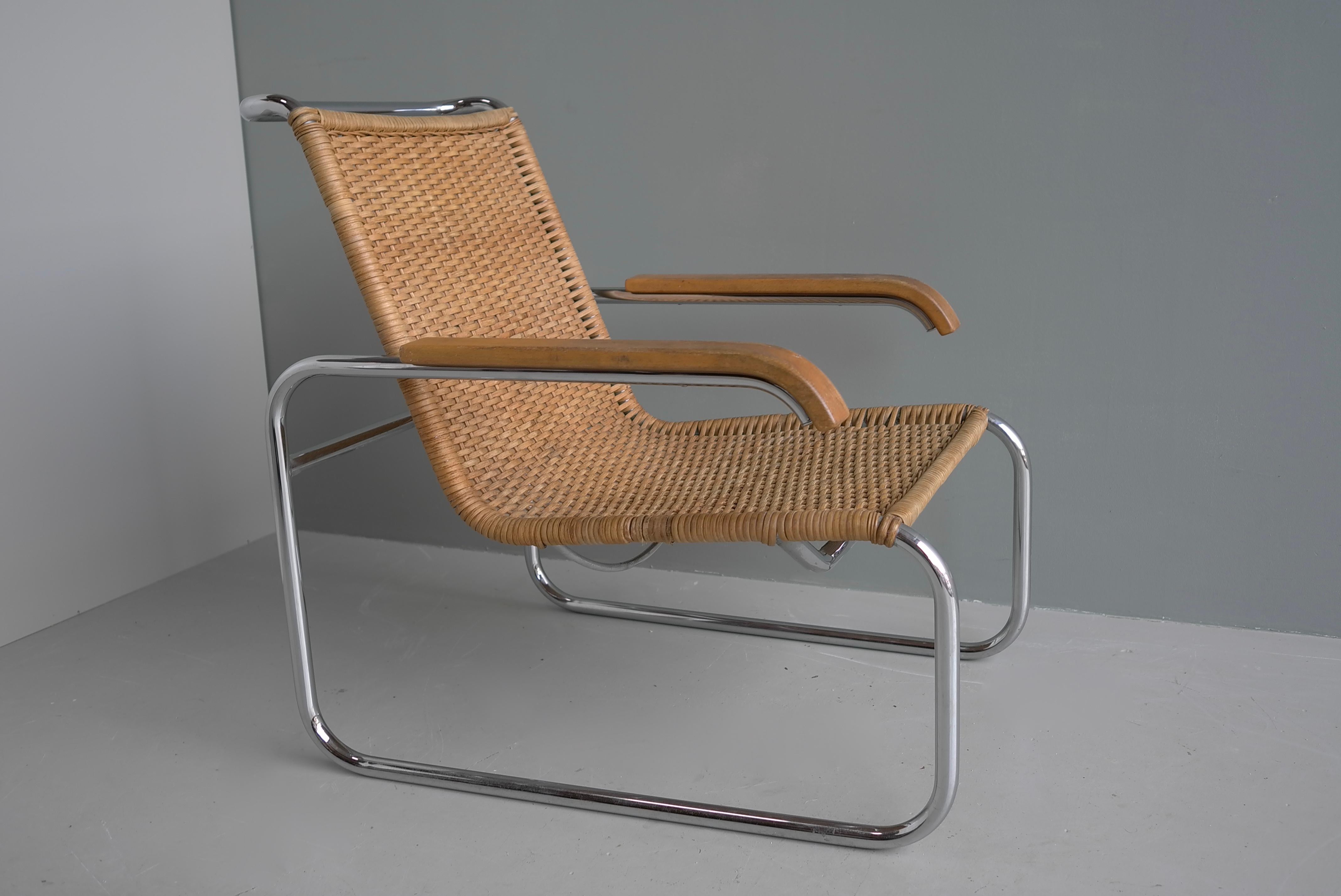Sublime Bauhaus design by Marcel Breuer the B35 armchair by Thonet circa 1960s, the cantilever frame with woven rattan seat, wooden armrests with a chromed tubular steel frame. Purchased at Metz en co early 1960's, it wears the Thonet sticker