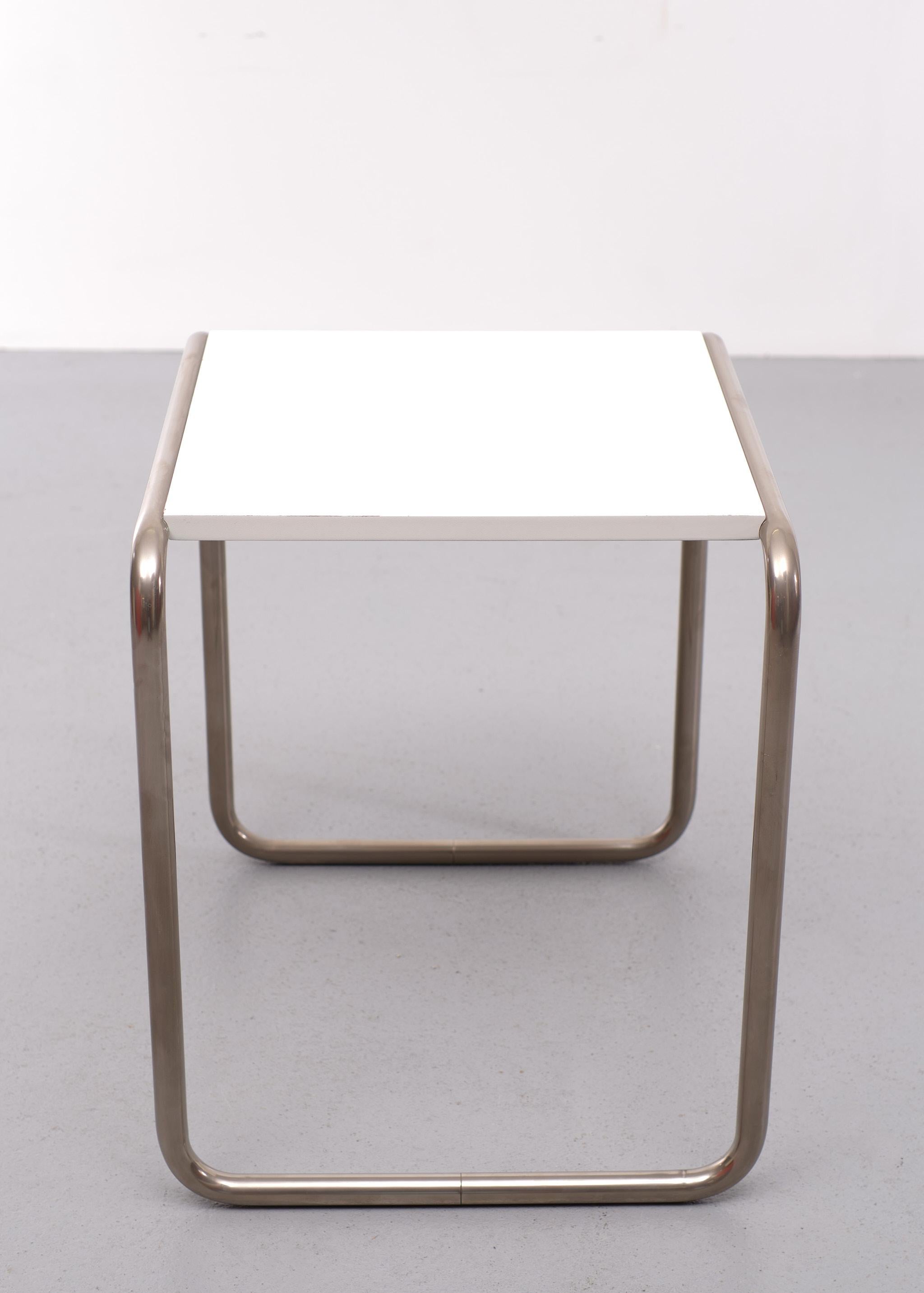 Beautiful solid side table designed by Marcel Breuer for the Bauhaus. It is marked with the Bauhaus logo and produced by Tecta Lauenförde. These tables have not been available for a long time.

Light traces of use on the blade; the steel is in