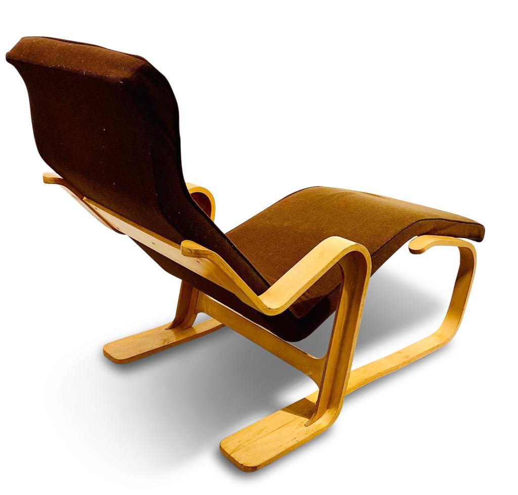 Marcel Breuer’s long chair manufactured by Isokon, 1960s. This iconic piece features a brown fabric upholstery on a sculptural bentwood frame.

Reclining chair of laminated (birch) ply, the angled backrest and shaped seat of one continuous piece
