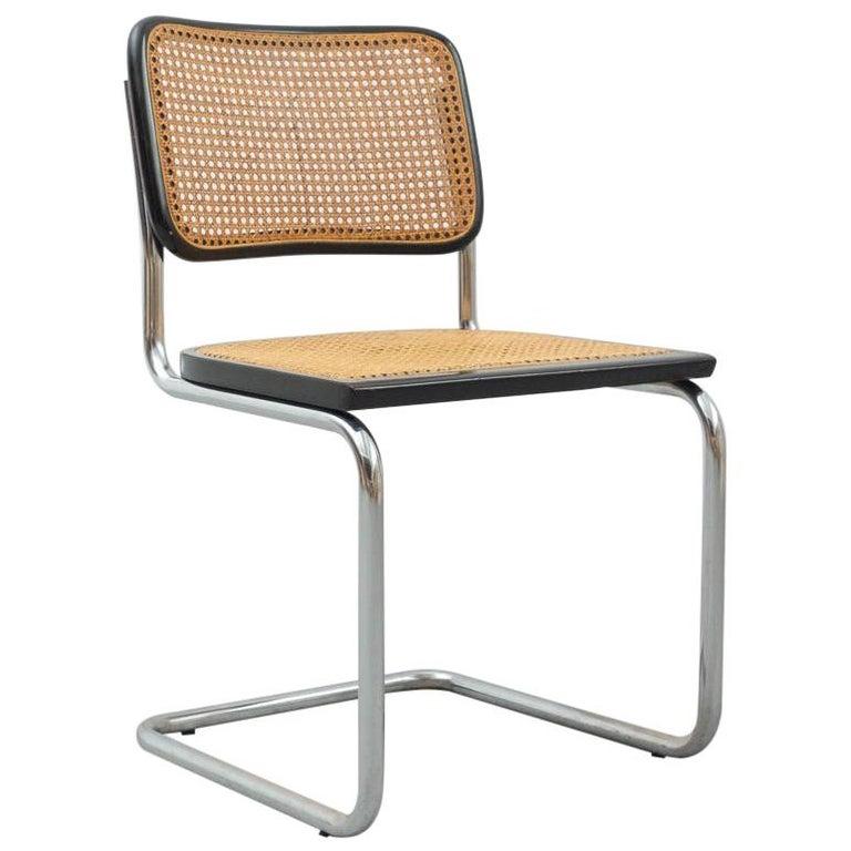 Chair model cantilever, designed by Marcel Breuer circa 1960, by unknown manufacturer.
Metal pipe frame, wood seat and back structure and rattan.

In original condition, with minor wear consistent with age and use, preserving a beautiful patina.