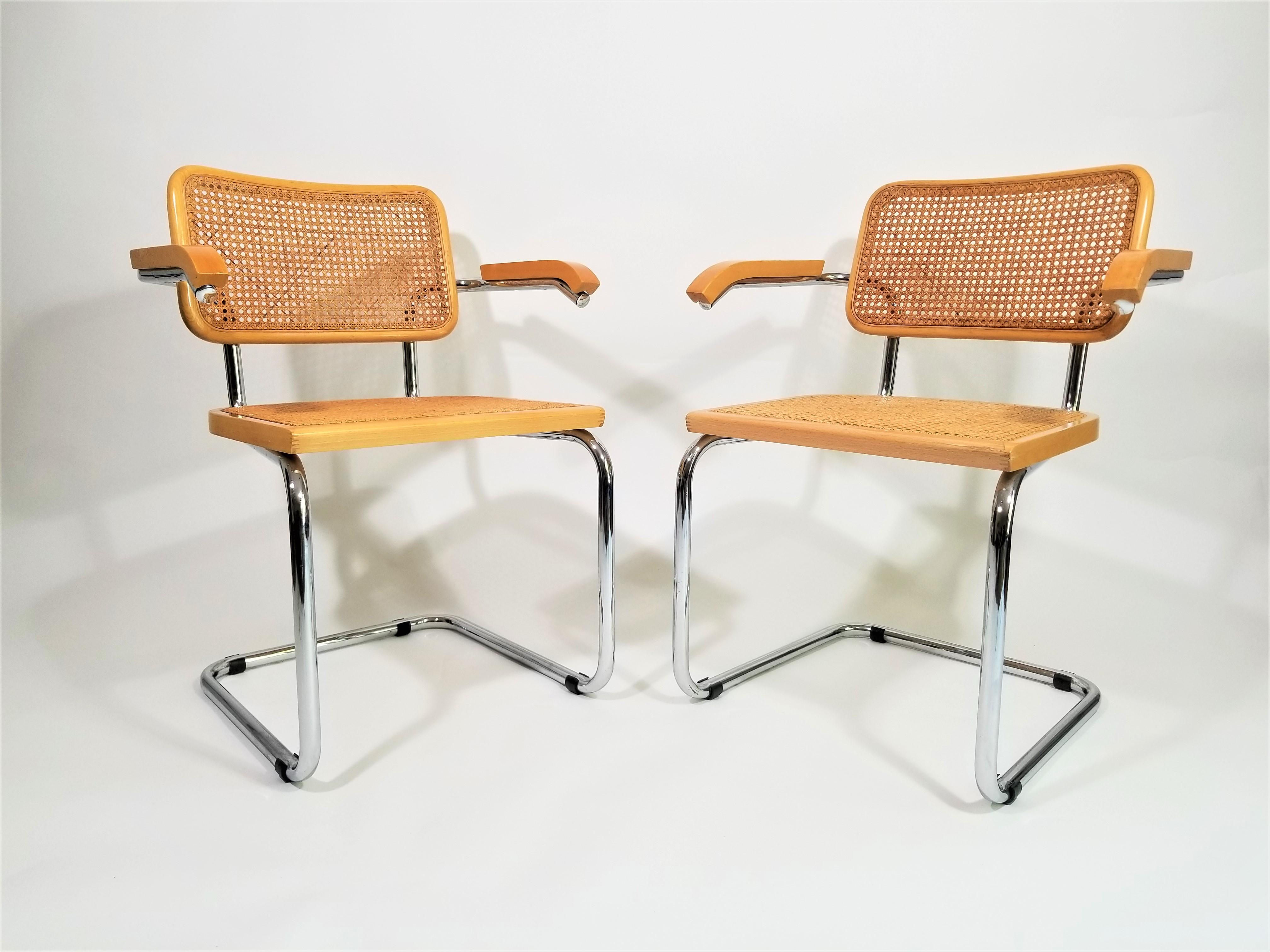 Stunning pair of midcentury Marcel Breuer Cesca armchairs in natural finish. Cane seats and backs. Classic chrome cantilever frames. Caning intact. We polish all chrome. Black protectors on chrome are removable.