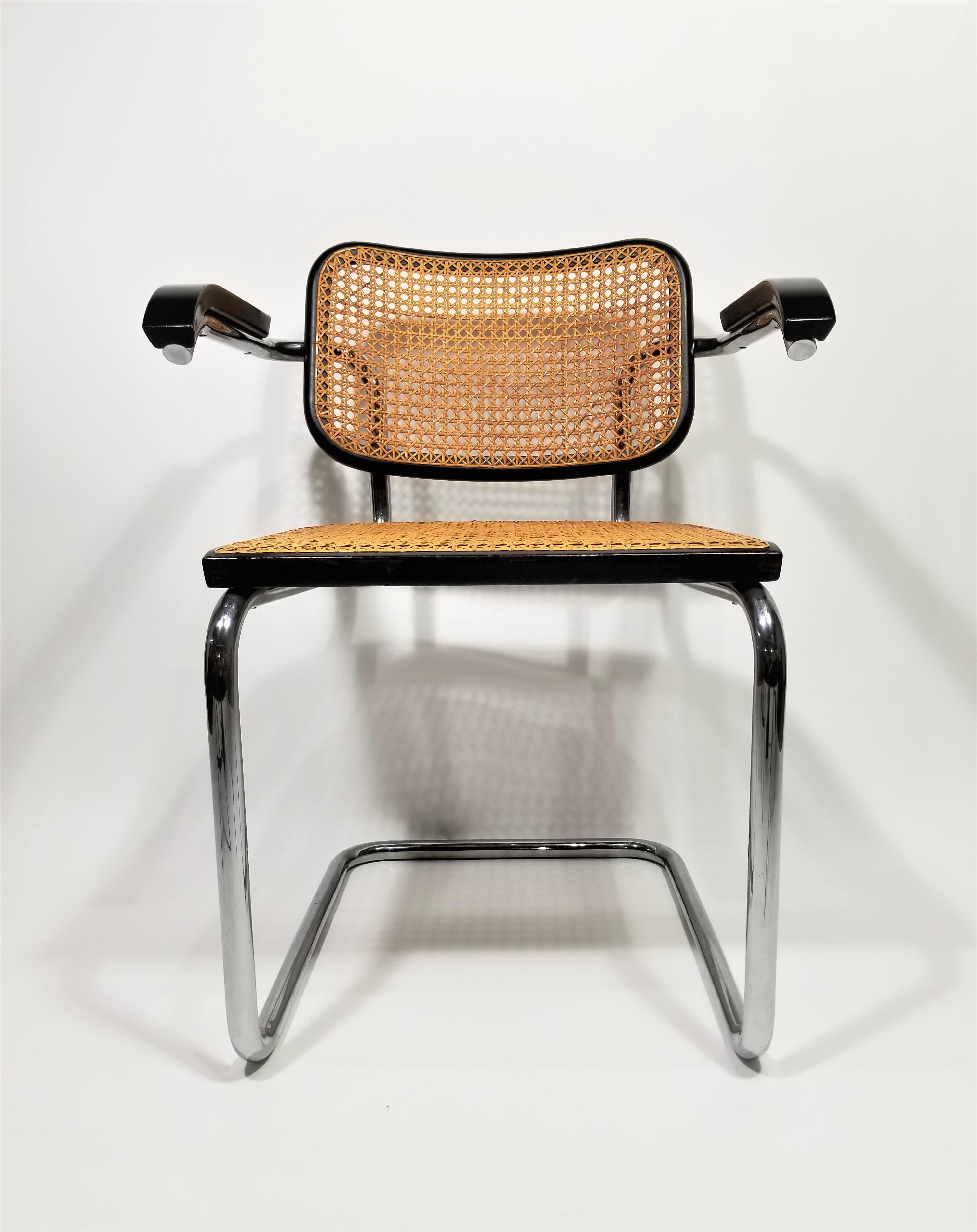 Rare authentic midcentury 1960s production Marcel Breuer Cesca armchair with black finish by Stendig. Hand caned seat and back. Signed with original marking stickers on both seat and back. Classic chrome cantilever frames.

Complimentary delivery in