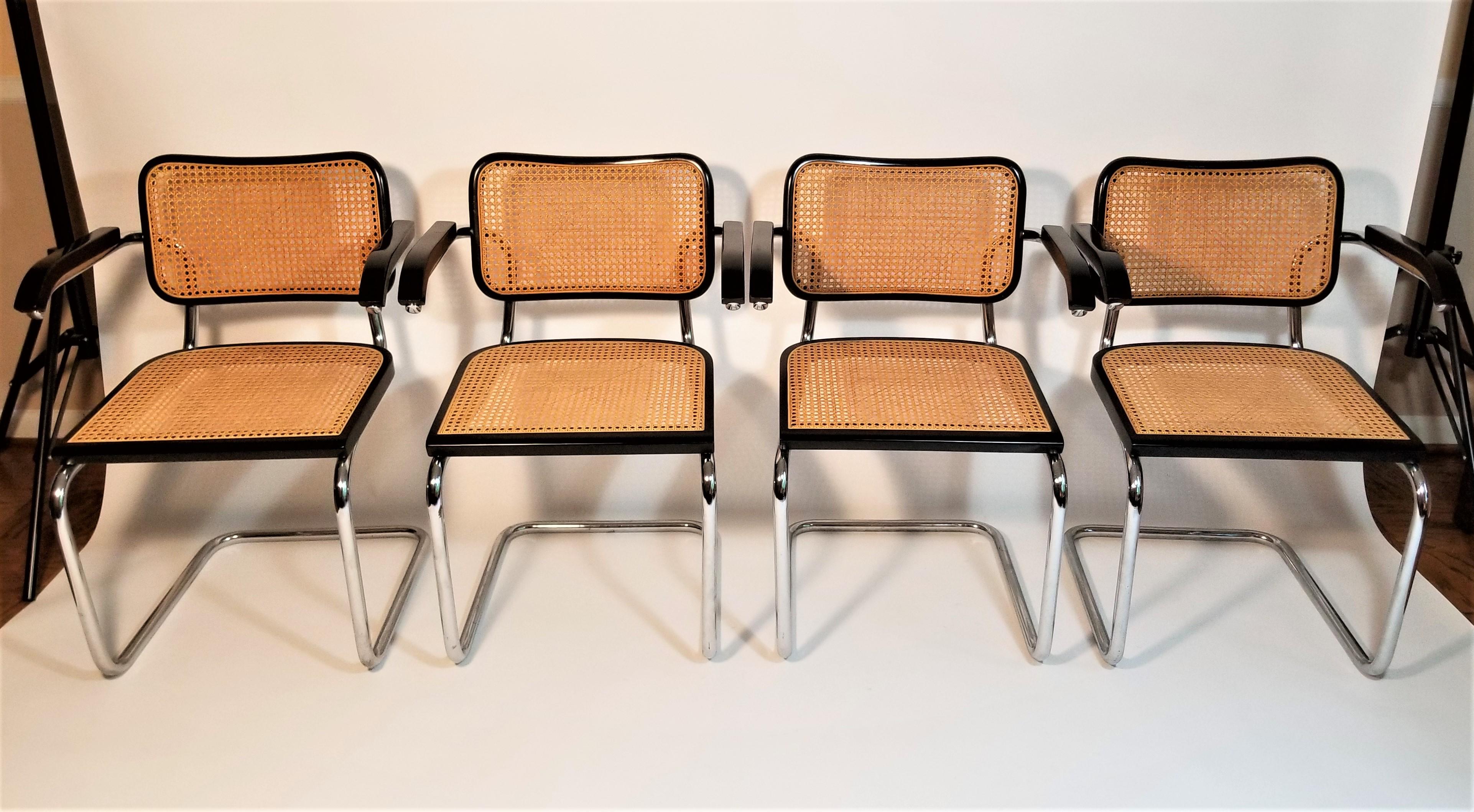 Set of 4 midcentury 1980s Marcel Breuer Cesca Black armchairs. Acquired from the estate of owner who purchased the entire set in the 1980s. Black finish. Cane seats and backs. Classic chrome tubular cantilever frames. We polish all chrome.