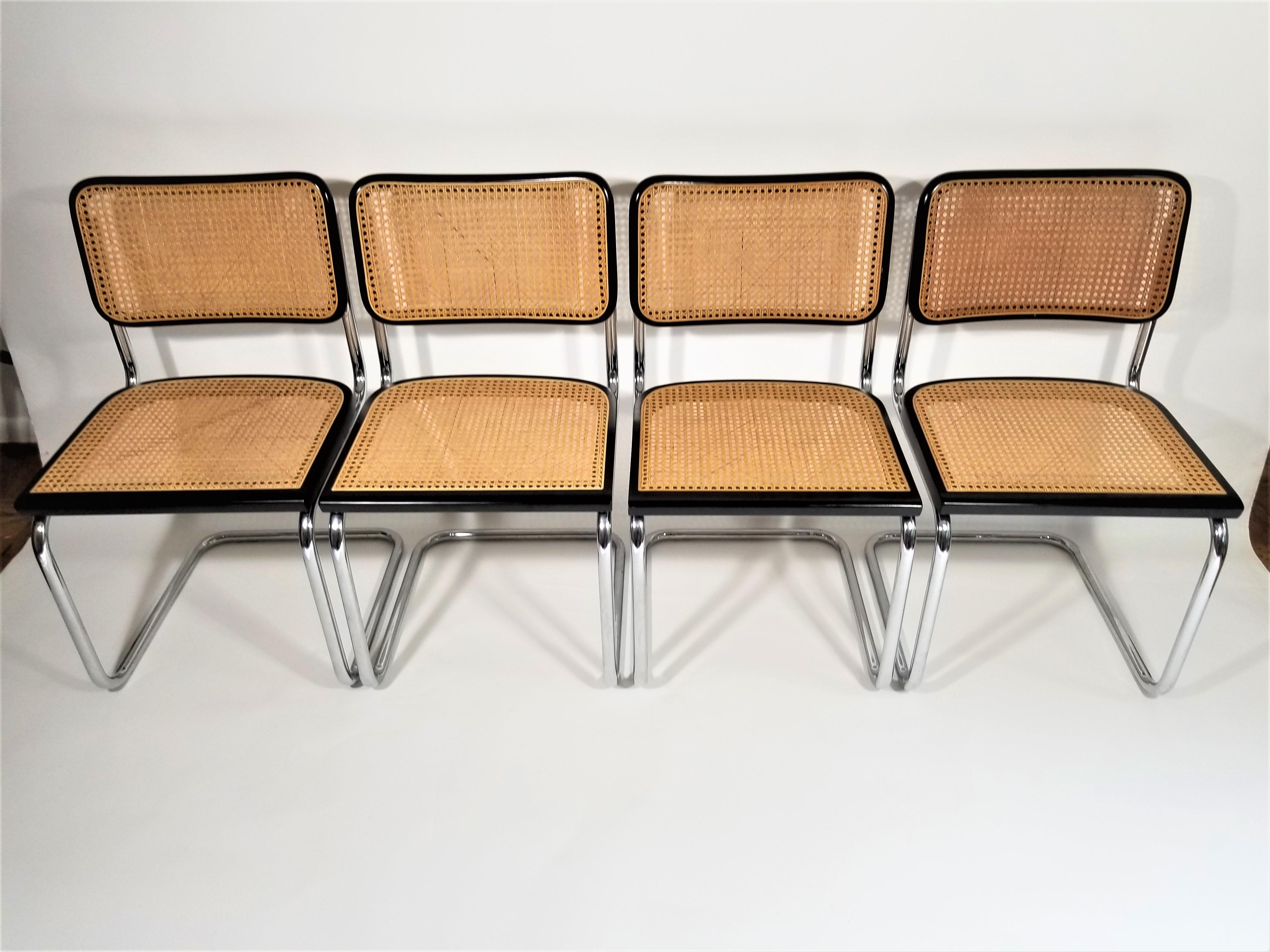 Set of 4 Marcel Breuer Cesca side chairs with black finish. Cane seats and backs. Classic chrome cantilever frames. We polish all chrome.