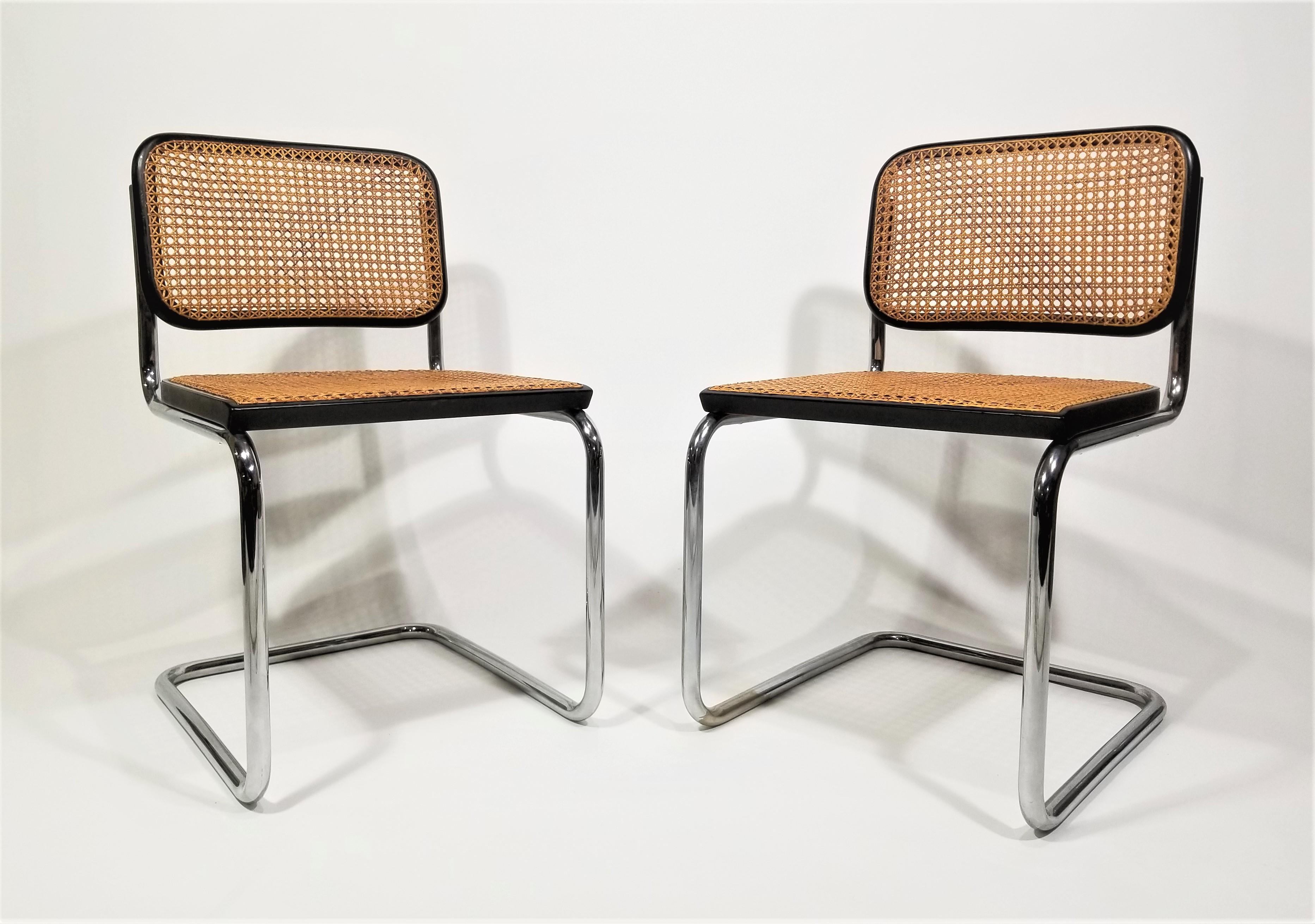 Authentic mid century 1960s Marcel Breuer Cesca side chairs by Stendig. Original markings on back, seat and chrome frame. Black finish. Beautiful hand caned Carmel color cane on seats and backs. Classic cantilever chrome frames. 

Rare to find in