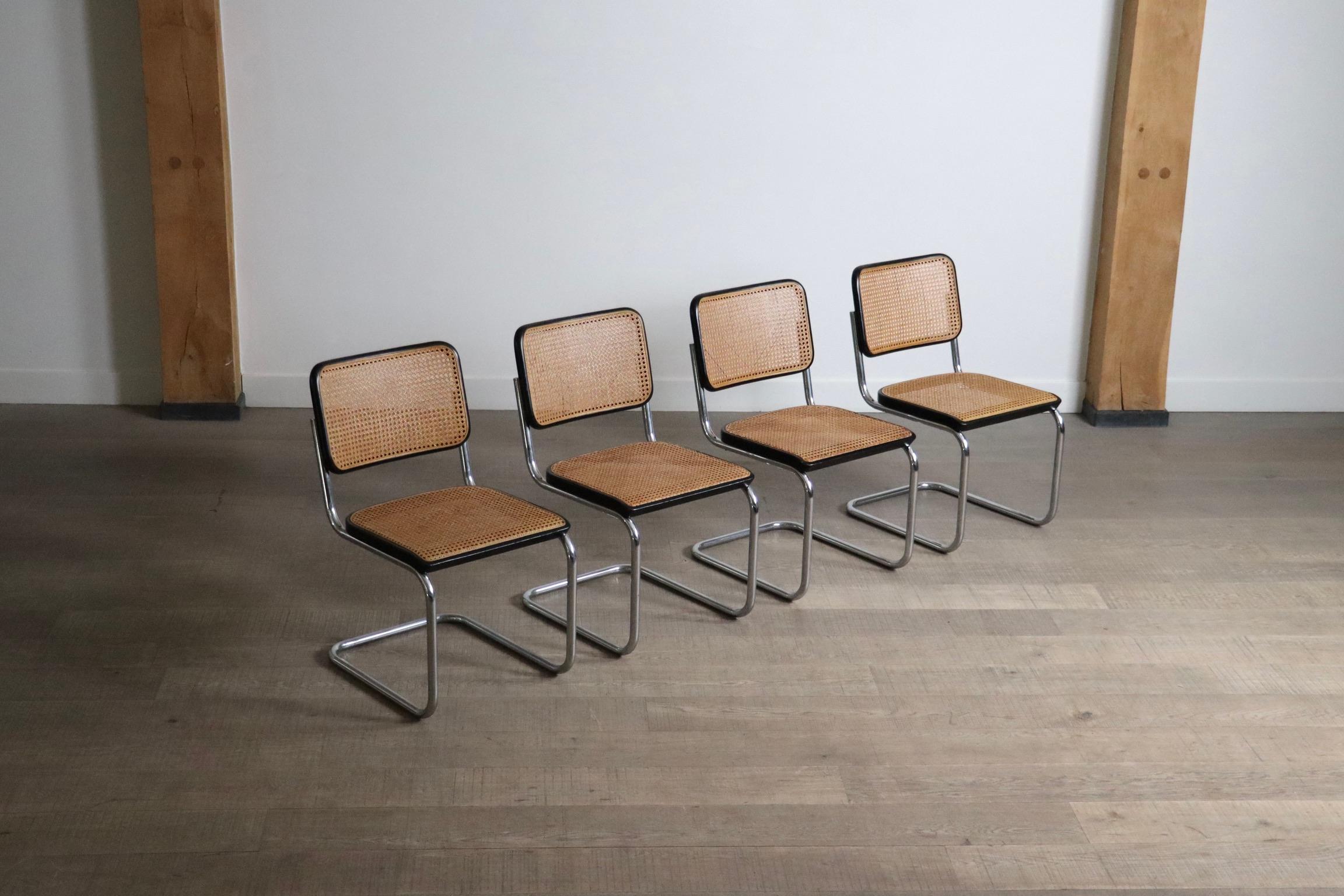 Beautiful set of four Cesca dining chairs in chrome, webbing and black stained seat by Marcel Breuer for Thonet, 1970s.

A timeless classic which has been popular ever since it first came out. the sleek tubular chrome frame in combination with the