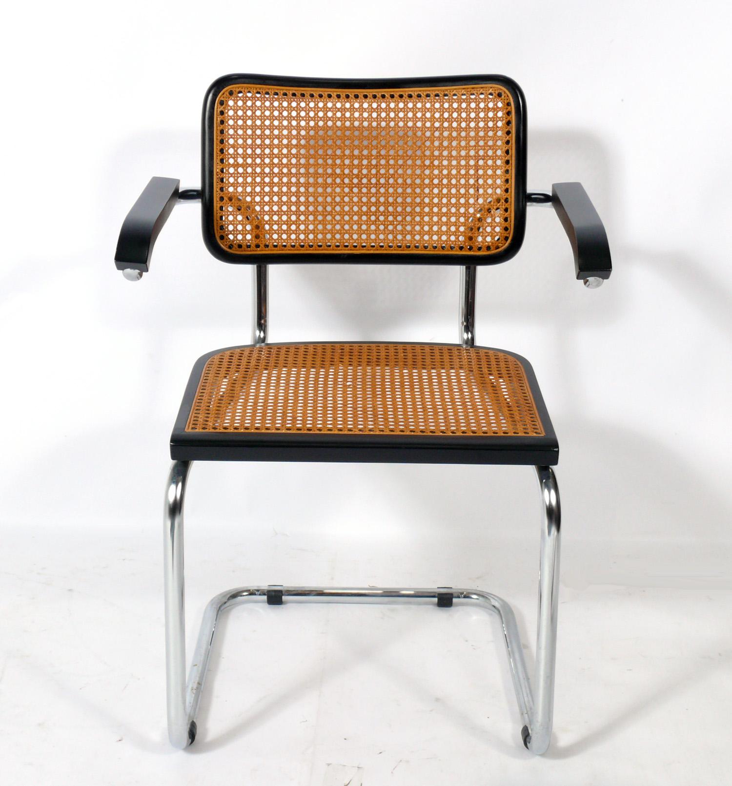 Sleek clean lined cesca dining chairs, designed by Marcel Breuer, these examples probably made by Gavina, Italy, circa 1960s. Several are marked Made In Italy. We have 8 arm chairs and 4 side chairs available. The arm chairs are $750 each and the