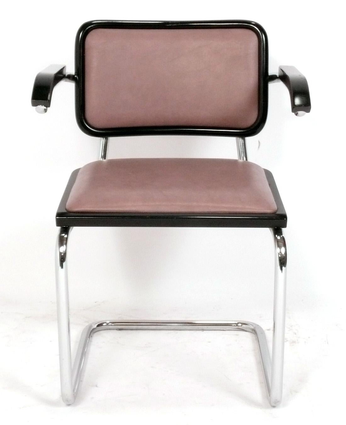 Set of Four Clean Lined Cesca Model Dining Chairs, designed by Marcel Breuer, and probably made by Gavina, Italy, circa 1980s. The set consists of four armchairs in black lacquer and low maintenance vinyl upholstery.