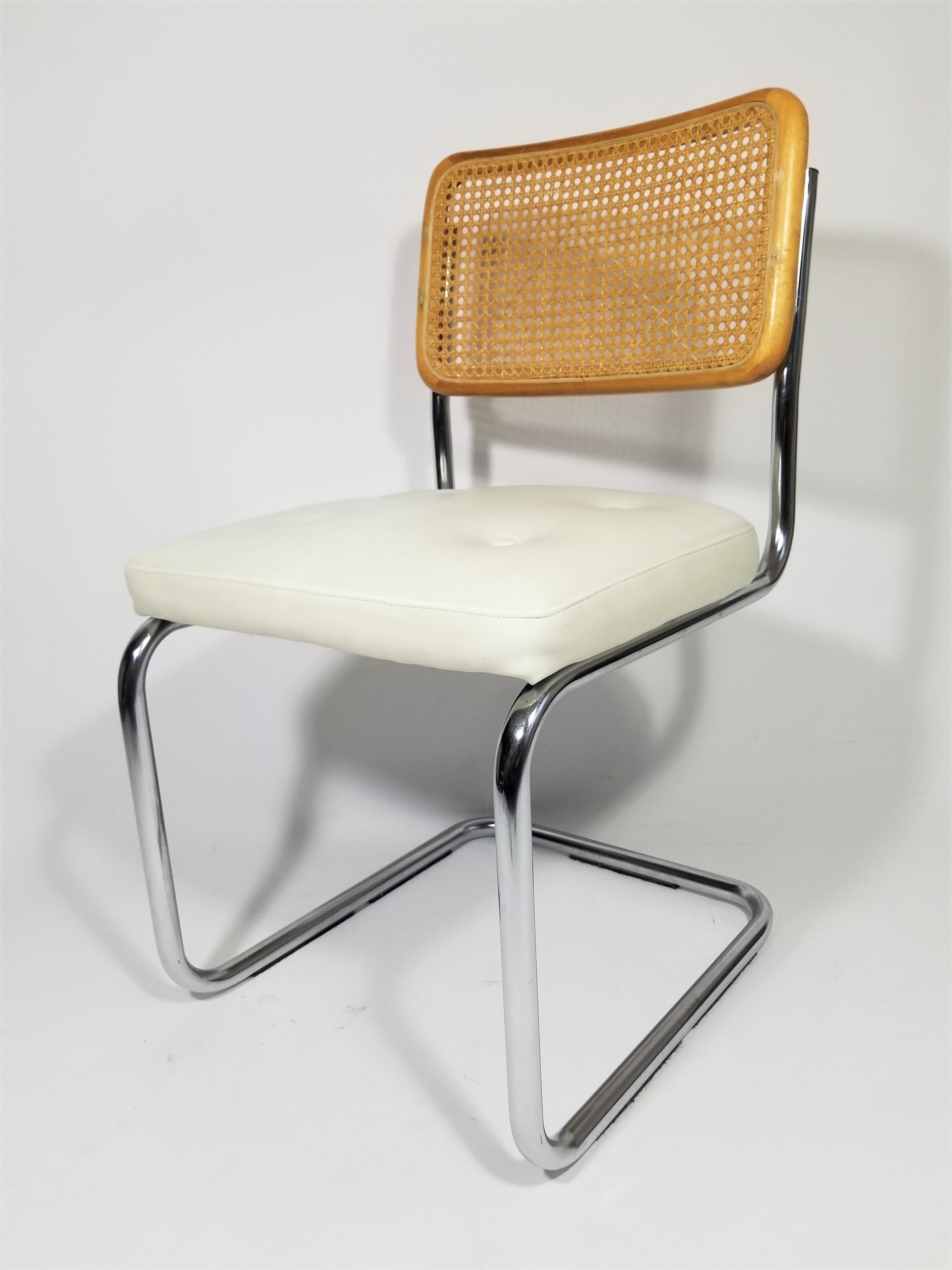 Midcentury Marcel Breuer Cesca side chair. Classic chrome steel frame. Cane back. White vinyl upholstered seat with covered buttons. This is a perfect Cesca chair for frequent sitting like a desk, vanity.
Complimentary delivery can be arranged for