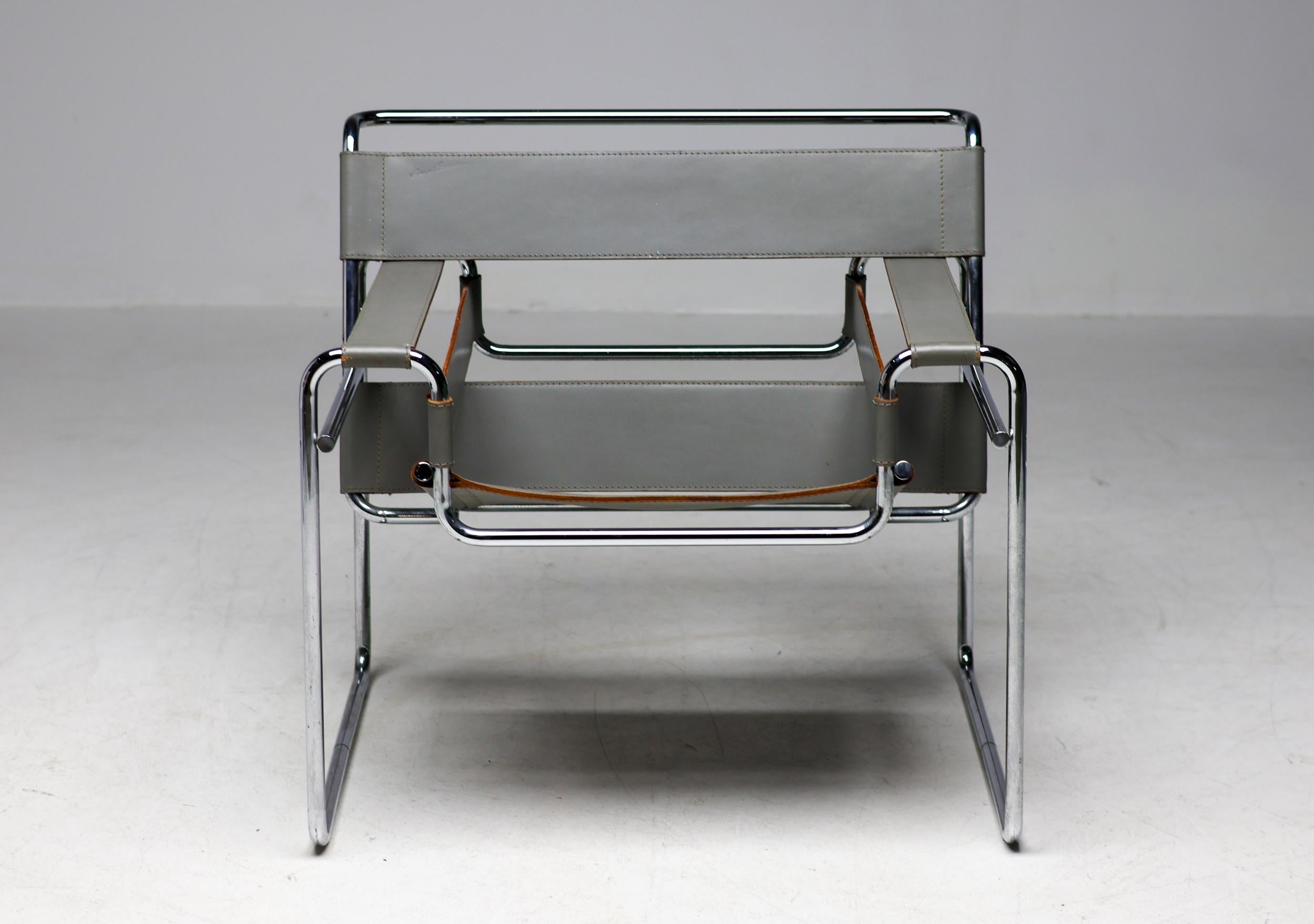 Early all original grey leather Wassily chair designed by Marcel Breuer, circa 1925. 
Manufactured circa 1960 by Gavina in Italy.  Made in beautiful grey saddle leather that compliments this radical modern design beautifully. The chromed tubular