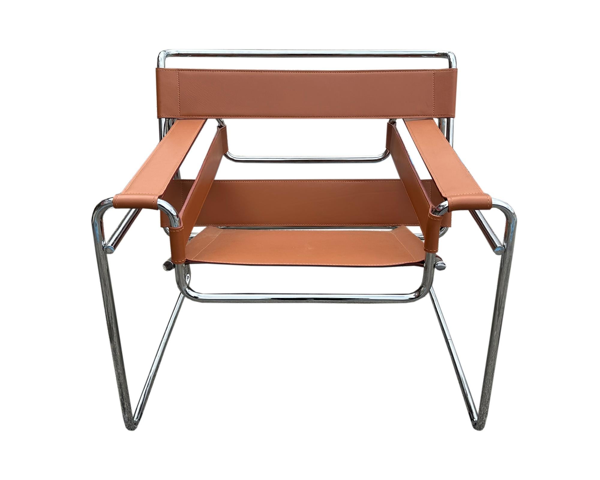 A warm brown leather and chrome Wassily chair designed by Hungarian architect and furniture designer Marcel Breuer (1902-1981) and produced by Knoll. Composed of a tubular chrome frame with brown leather straps positioned for comfortable seating,