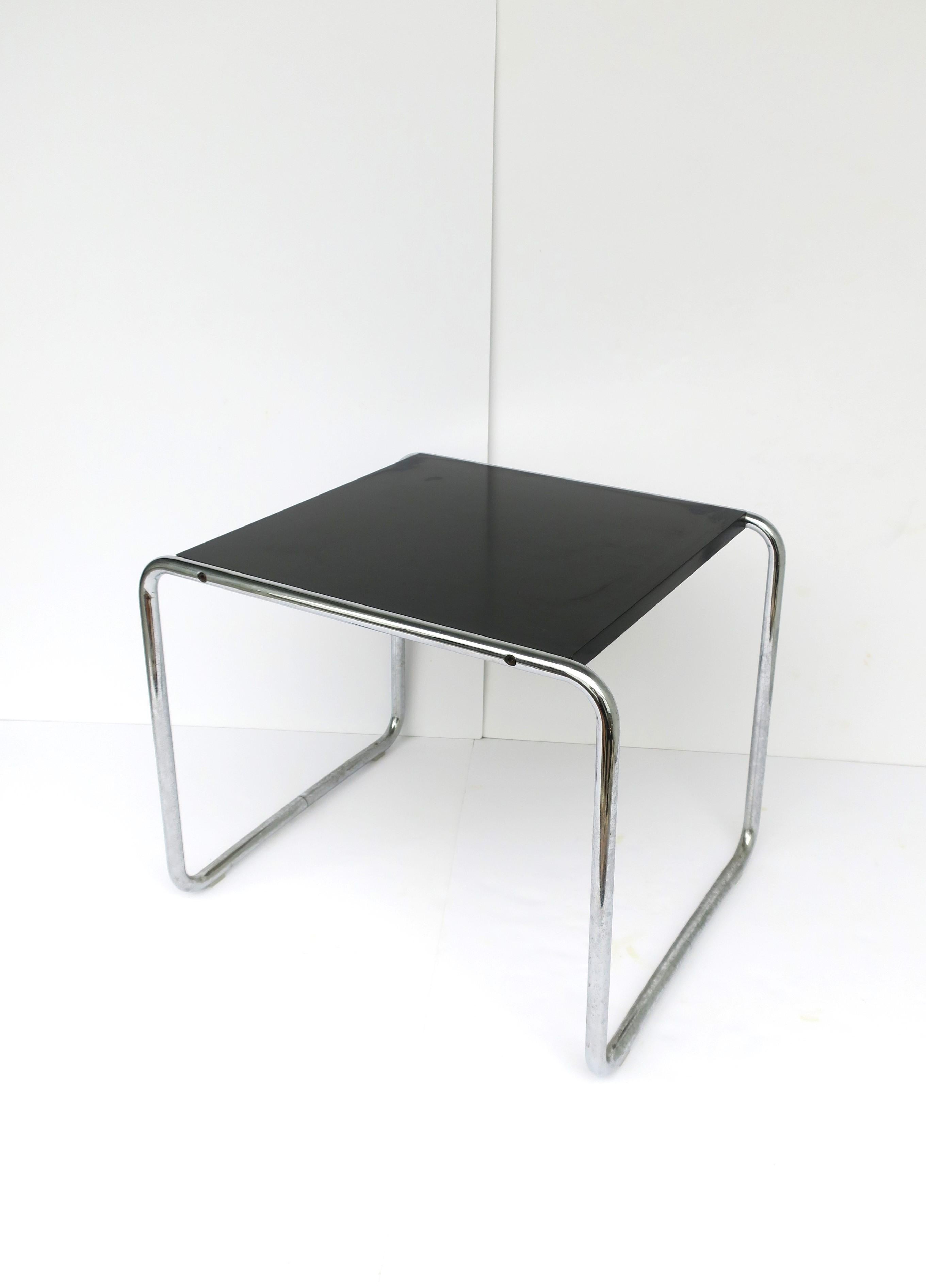 An authentic Marcel Breuer Laccio side or end table for Knoll Studio, in the German Bauhaus style, circa late-20th century. Table has a black laminate top and tubular chrome frame. Makers' and Designer marks in two places as shown in last three