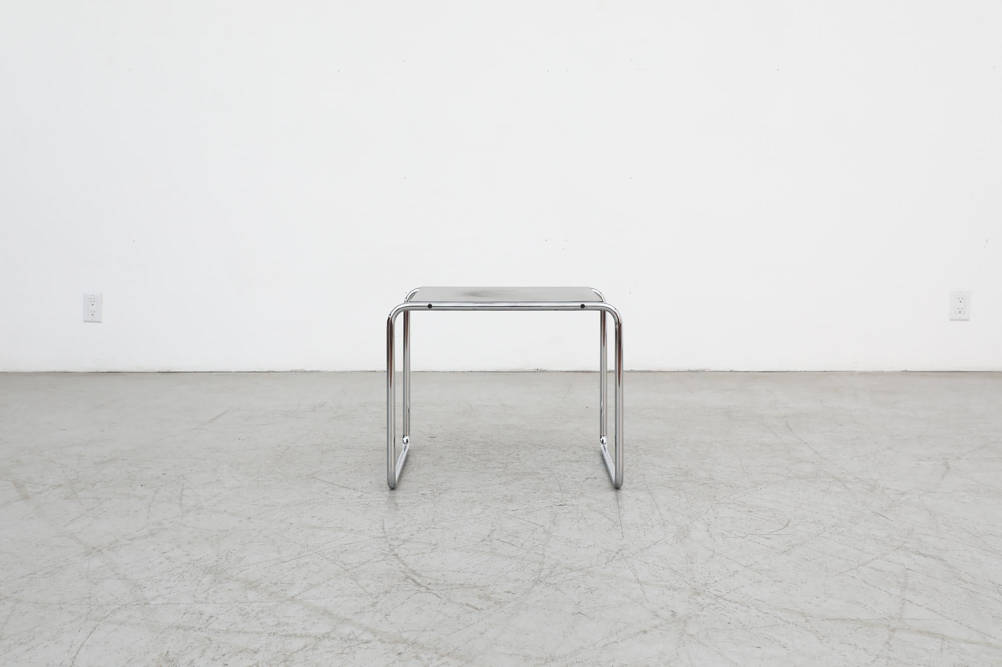 Iconic, 'Laccio' side table developed by Bauhaus great Marcel Breuer in 1925 and manufactured in 1962 by Italy's Gavina. Has a black laminate top with a chrome frame. Original manufacturer label on the side of the frame. In original condition with