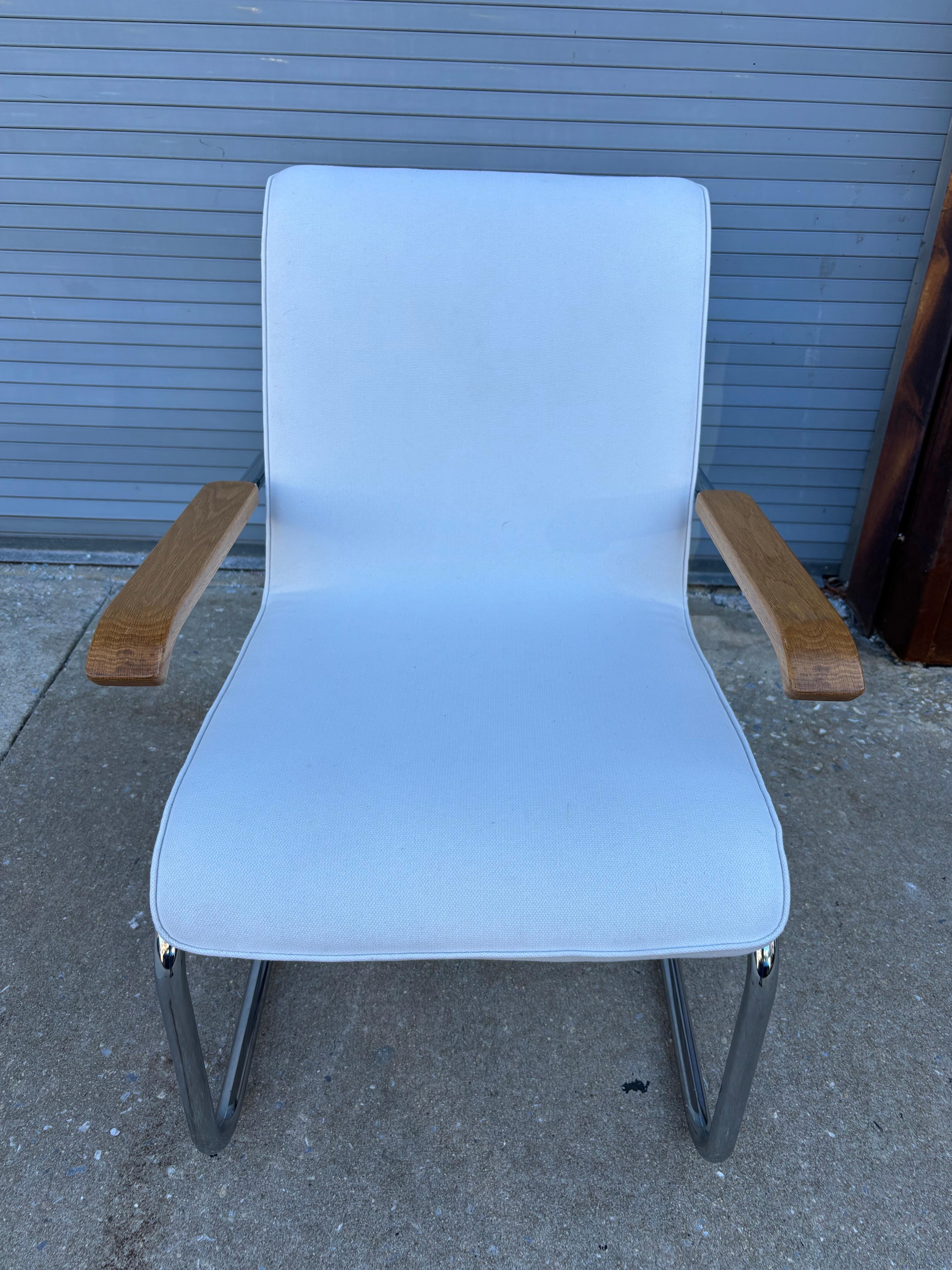 Marcel Breuer MB Chrome Lounge Chair in a white fabric Upholstery.  Chair gives a nice little flex when you sit.  Design has a cantilevered hanging seat.  Like new condition!