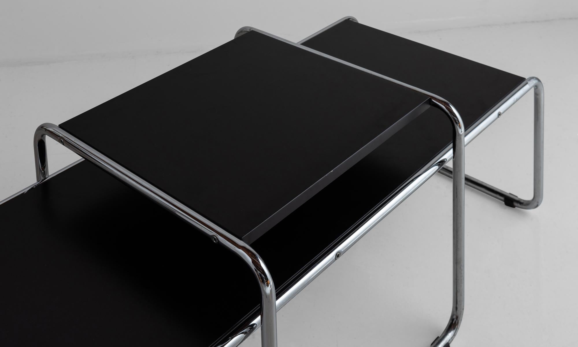 Bauhaus design. Chrome tubular frame with black laminate tops. Includes nesting coffee table and end table. 


Measures: 53