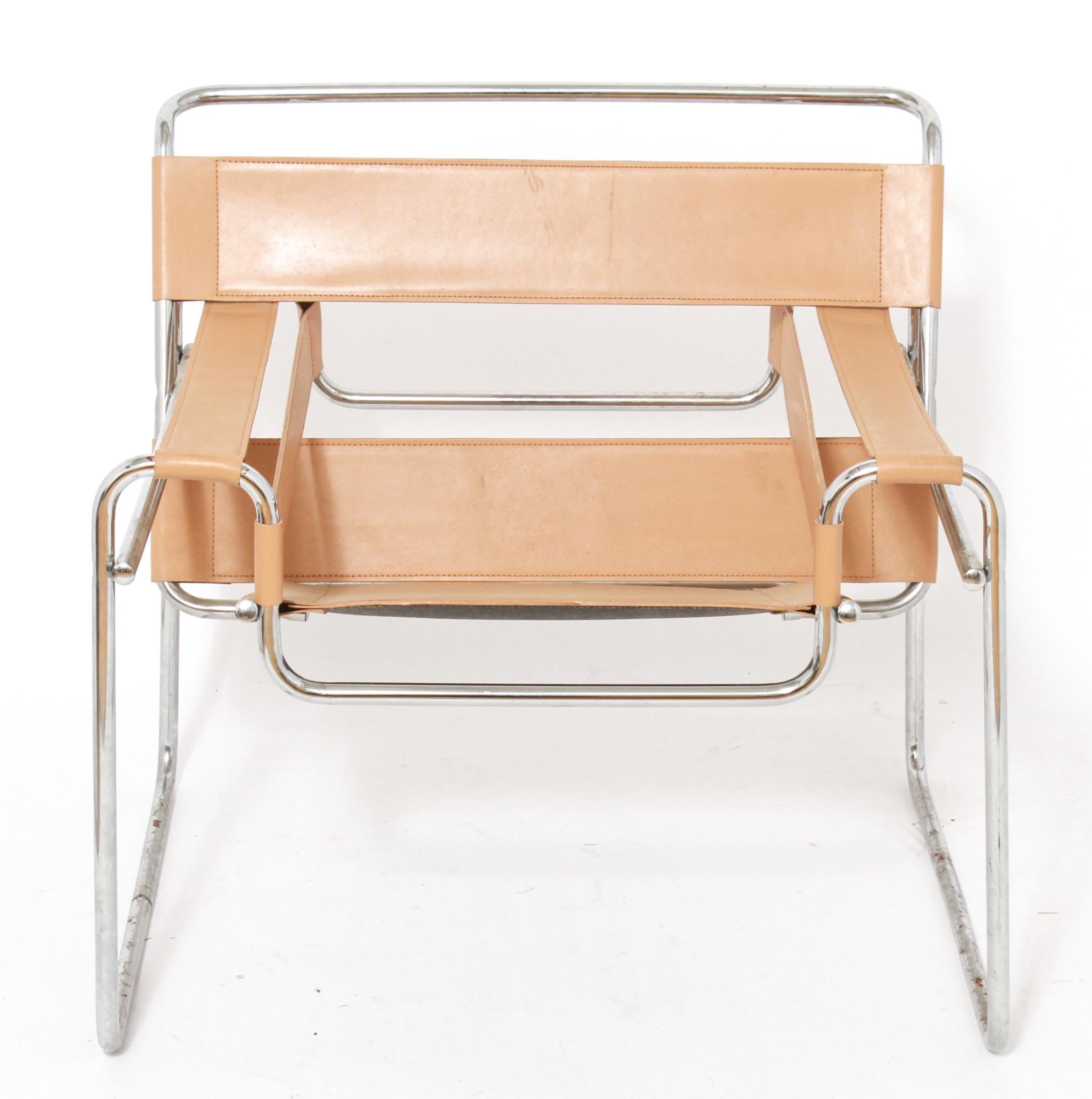 Pair of Marcel Breuer Wassily Model #B3 Mid-Century Modern lounge arm chairs, tan leather strap seat and back, with tubular chrome frame. Measures: 29