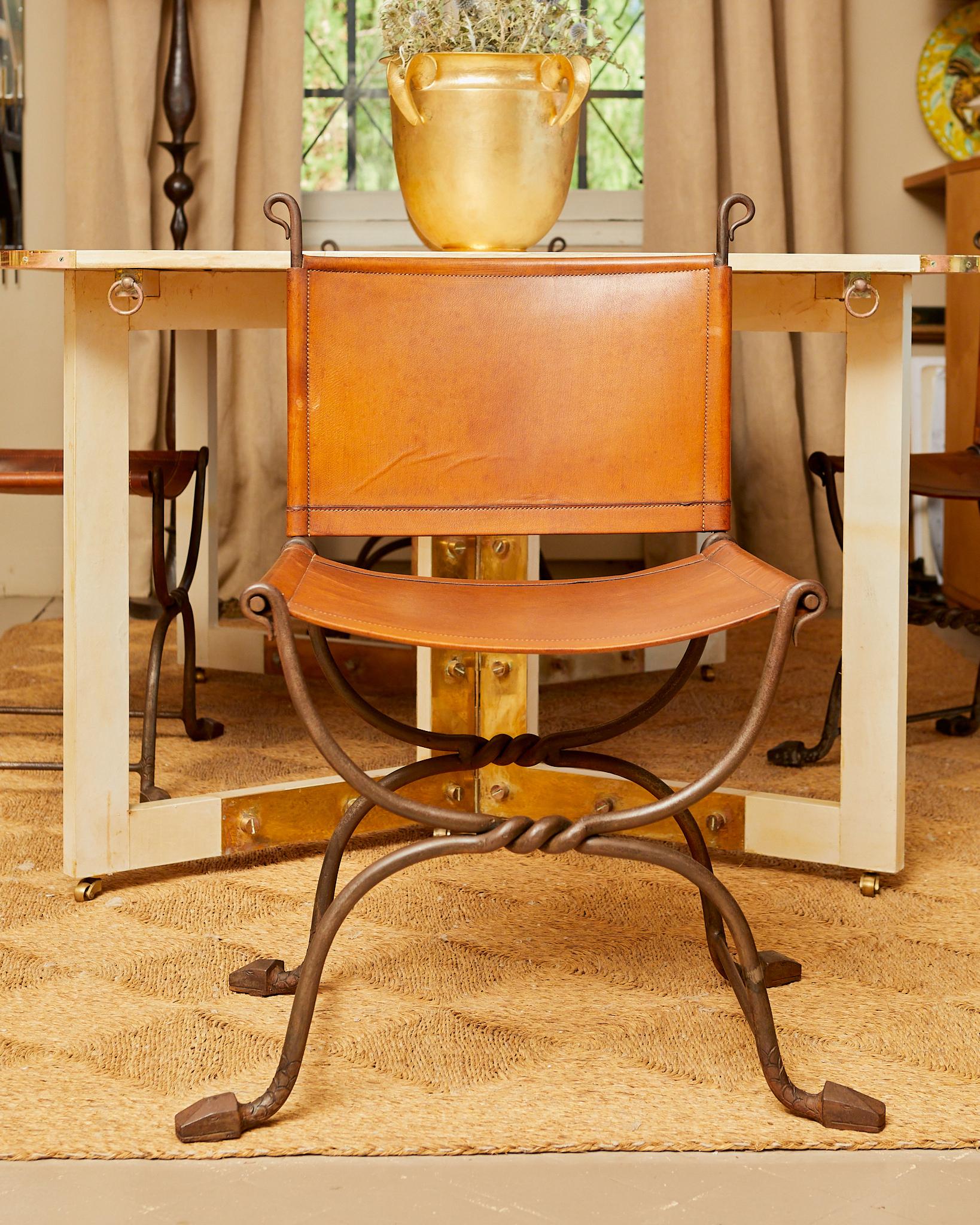 Marcel  Coard (1889 / 1975),
Set of four wrought iron chairs with X-shaped legs, twisted legs carved and chiseled with snake decoration, thick leather back and seat
(one leather chair reupholstered)
Circa 1940, France.
Height 82 cm
Seat height 42