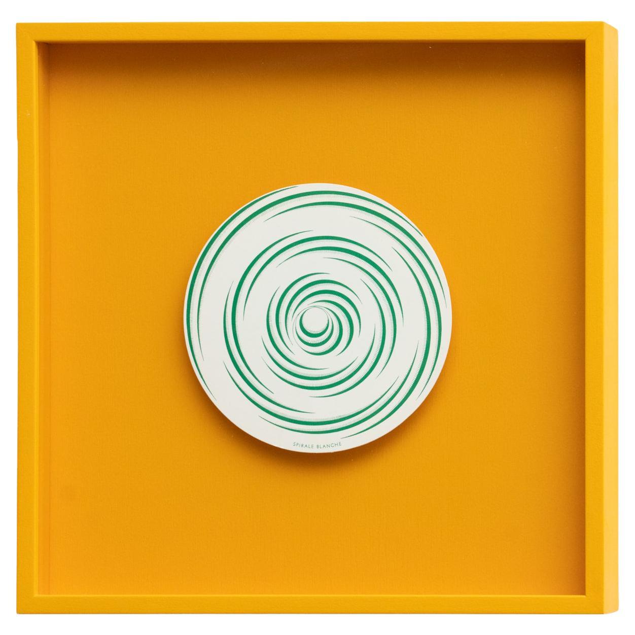 Enter the world of Marcel Duchamp's Rotorelief, a captivating piece from the 1987 Konig Series 133, elegantly framed in high-quality yellow. This particular Rotorelief, aptly named Spirale Blanche, unveils its mesmerizing patterns in shades of green