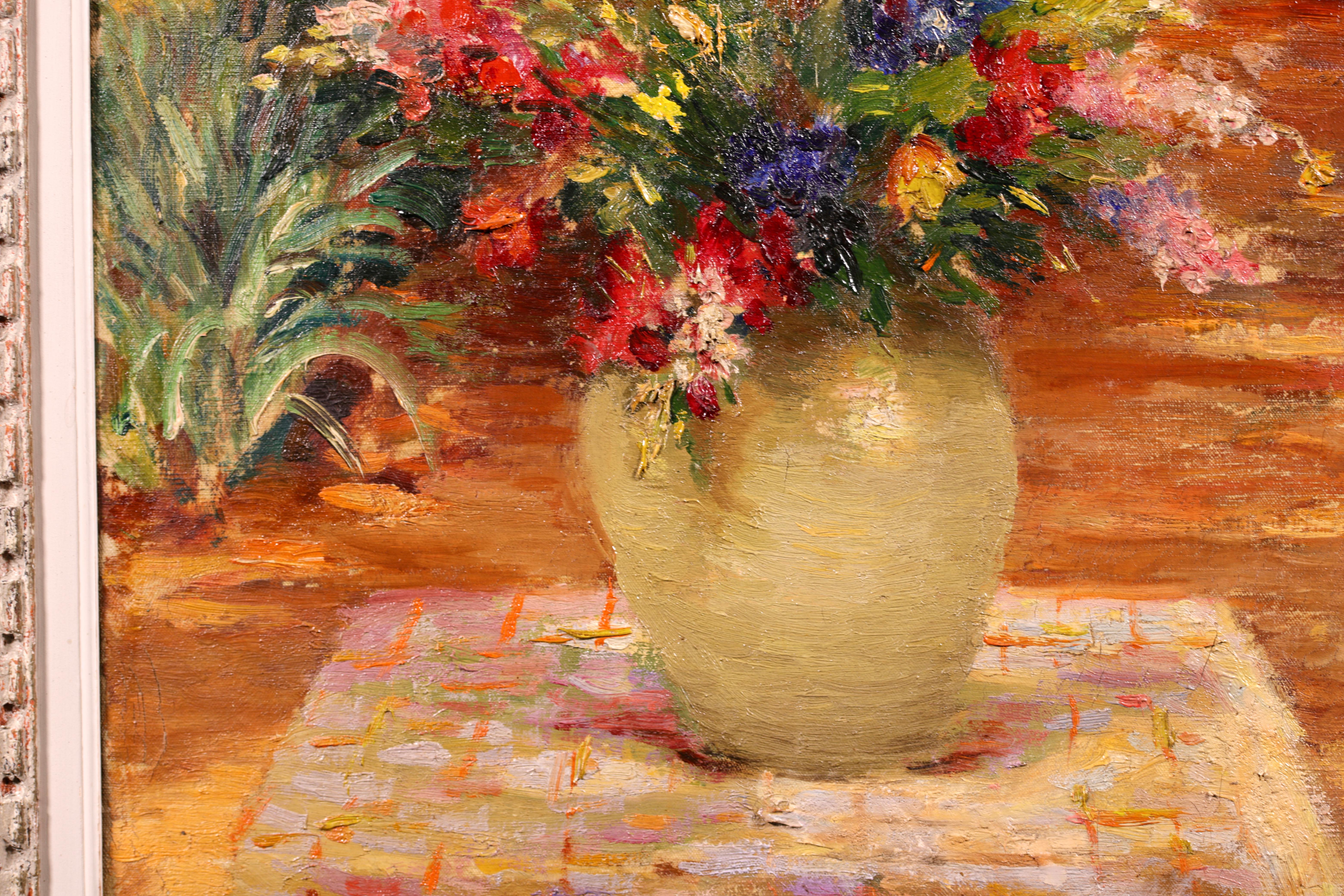 Signed post impressionist still life oil on canvas circa 1940 by sought after French impressionist painter Marcel Dyf. The work depicts a vase filled with flowers of all colours placed on a table in a garden. In the distance a young girl in a blue