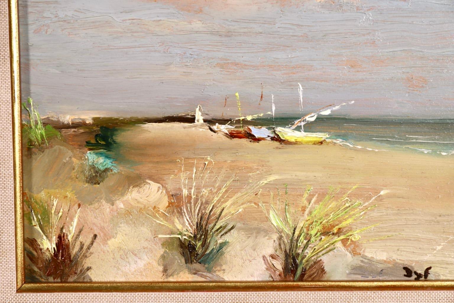 A wonderful oil on canvas by sought after French post impressionist painter Marcel Dyf depicting a view of the beach form the sand dunes at Les Saintes Maries de la Mer in Camargue in the South of France. A yellow and a brown fishing boat are