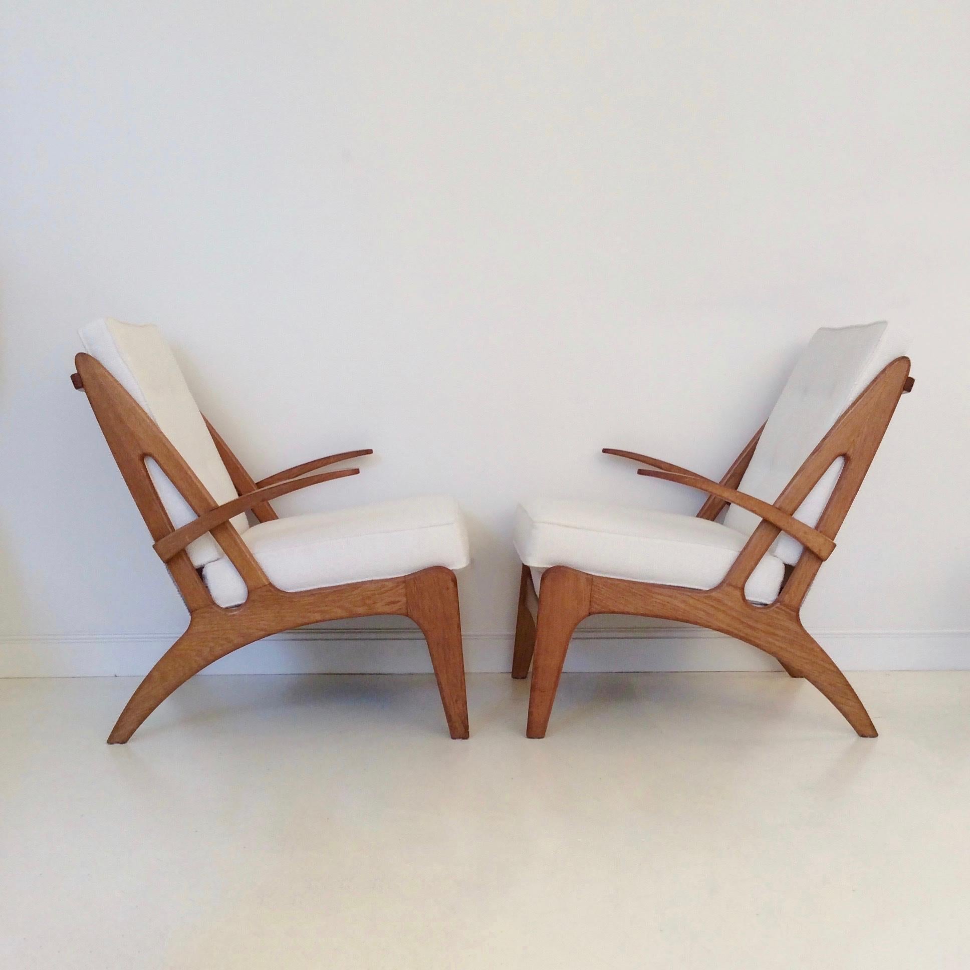 Rare pair of armchairs, design attributed to Marcel Louis Baugniet, circa 1950, Belgium.
Solid oak, new ivory upholstery.
Dimensions: 96 cm H, 66 cm W, 83 cm D, seat height 45 cm.
Very good condition.
 