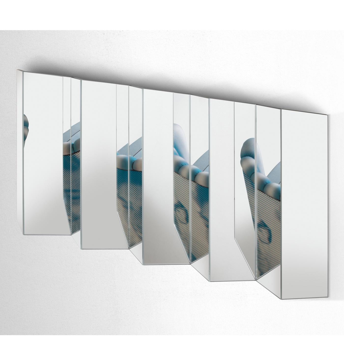 Inspired by the rigor and repetitiveness of mathematics, this wall mirror by Marco Brunori is made of a series of mirrored glass surfaces six mm which with a beveled edge that can be combined together both horizontally and vertically. The base for