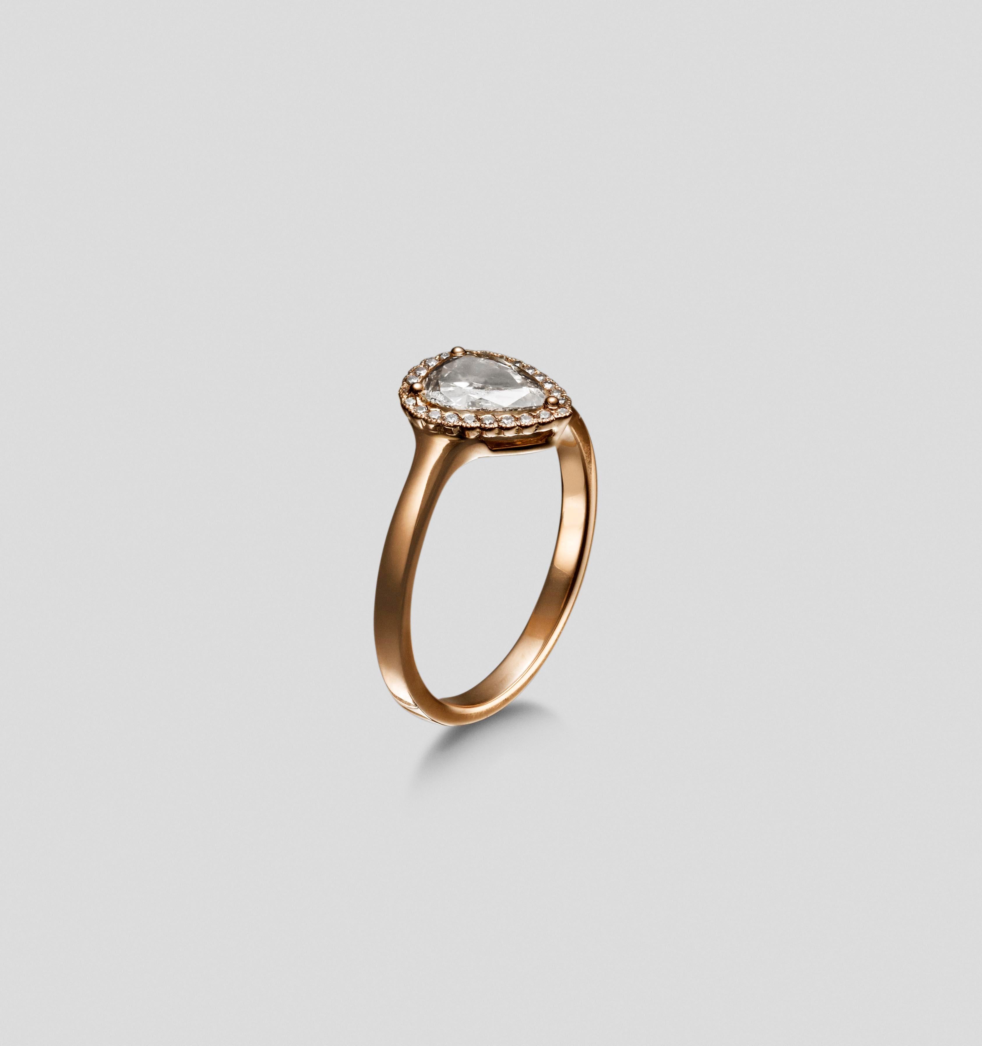 This gorgeous rose gold ring is part of the Zahr collection.  It blends colour and shapes.  

The ring is set with a pear shaped champagne diamond at the centre and is surrounded with a halo of twenty three 1 mm round brilliant cut diamonds. 