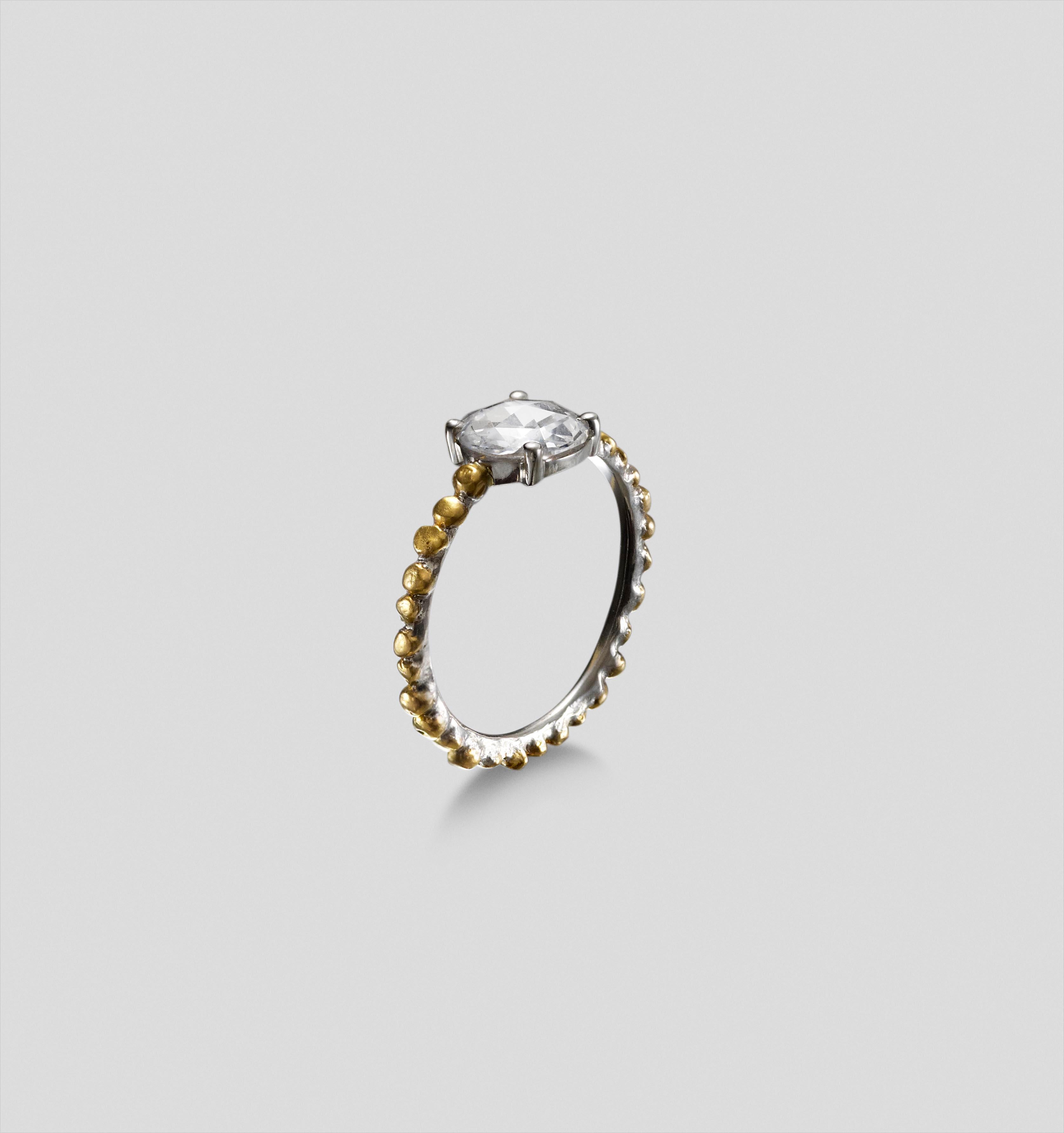 This collection bonds together the beautiful intensity of 24 carat gold with polished platinum to create a luxurious look with a raw and organic style.  The ring sits low on the finger and has a groove under the collet to fit a matching band.

A