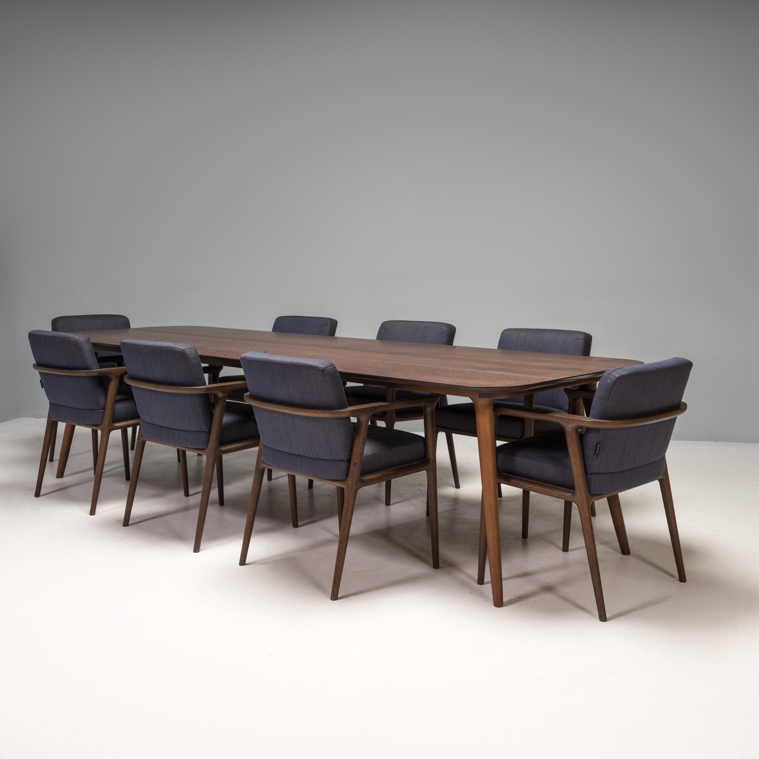 Originally designed by Marcel Wanders for Moooi in 2013, the Zio range exudes classic elegance.

Comprising a dining table and eight dining chairs, this set is constructed from wenge stained oak.

The dining chairs feature tapered legs and a