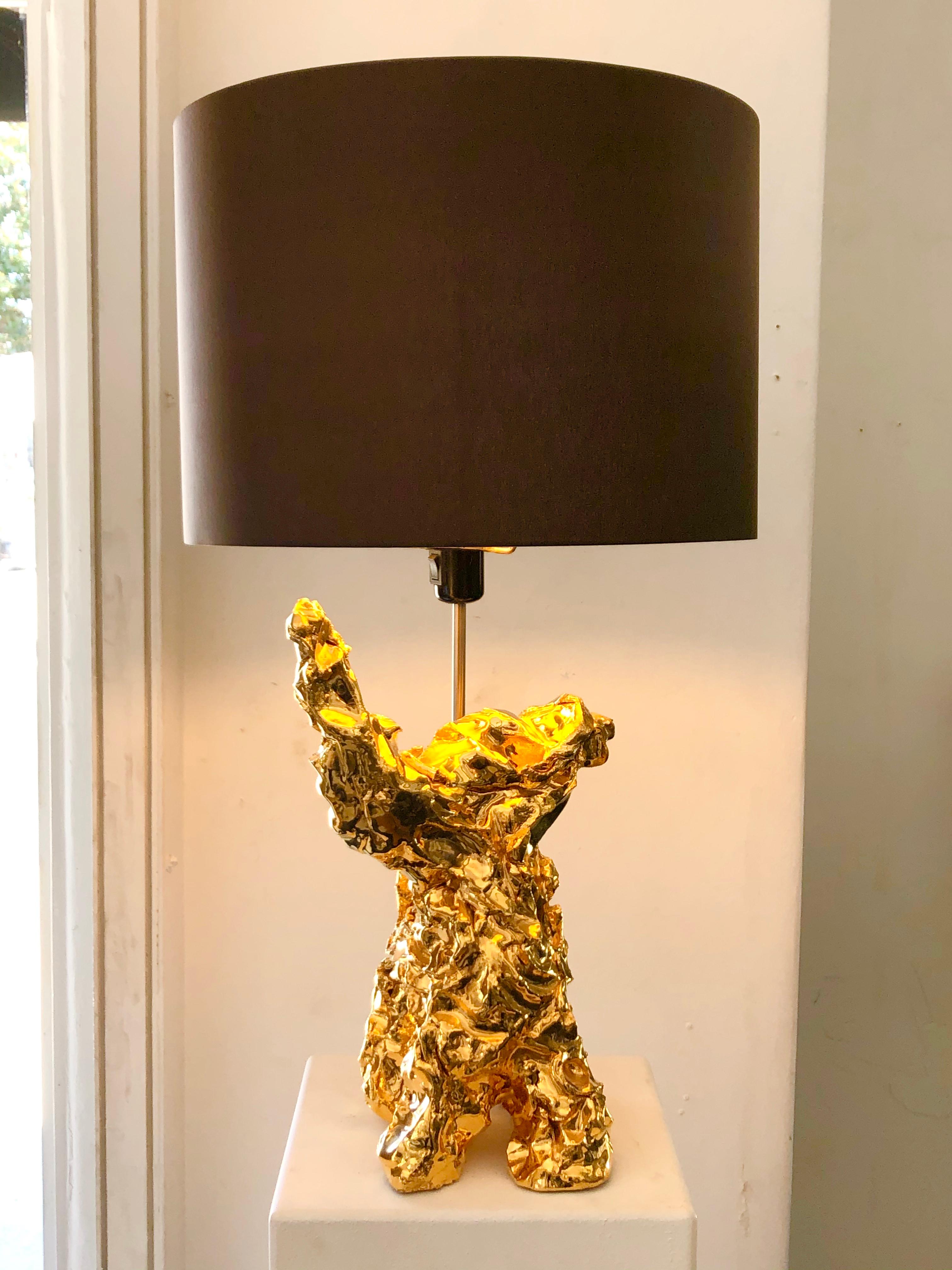 Most unique table lamp by Marcel Wandres. Gilt-glazed ceramic, stainless steel, linen, Netherlands, 2016.
In this limited series, the artist challenged himself to create a sculpture in no less than one minute from a shapeless pile of clay. He was