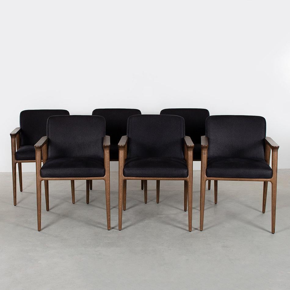 Nice set of 6 Zio dining chairs designed by Marcel Wanders for Moooi in 2013. Solid dark brown stained oak frames with black upholstered cushions all in very good condition. Only minimal traces of wear.