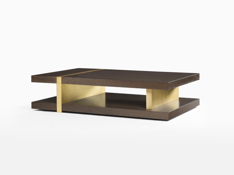 Modern and minimal, the Marcelle Cocktail Table features vertical metal elements bisecting expertly crafted walnut top and lower shelf. Inspired by intersecting planes, this coffee table showcases the inherit beauty of the materials used while