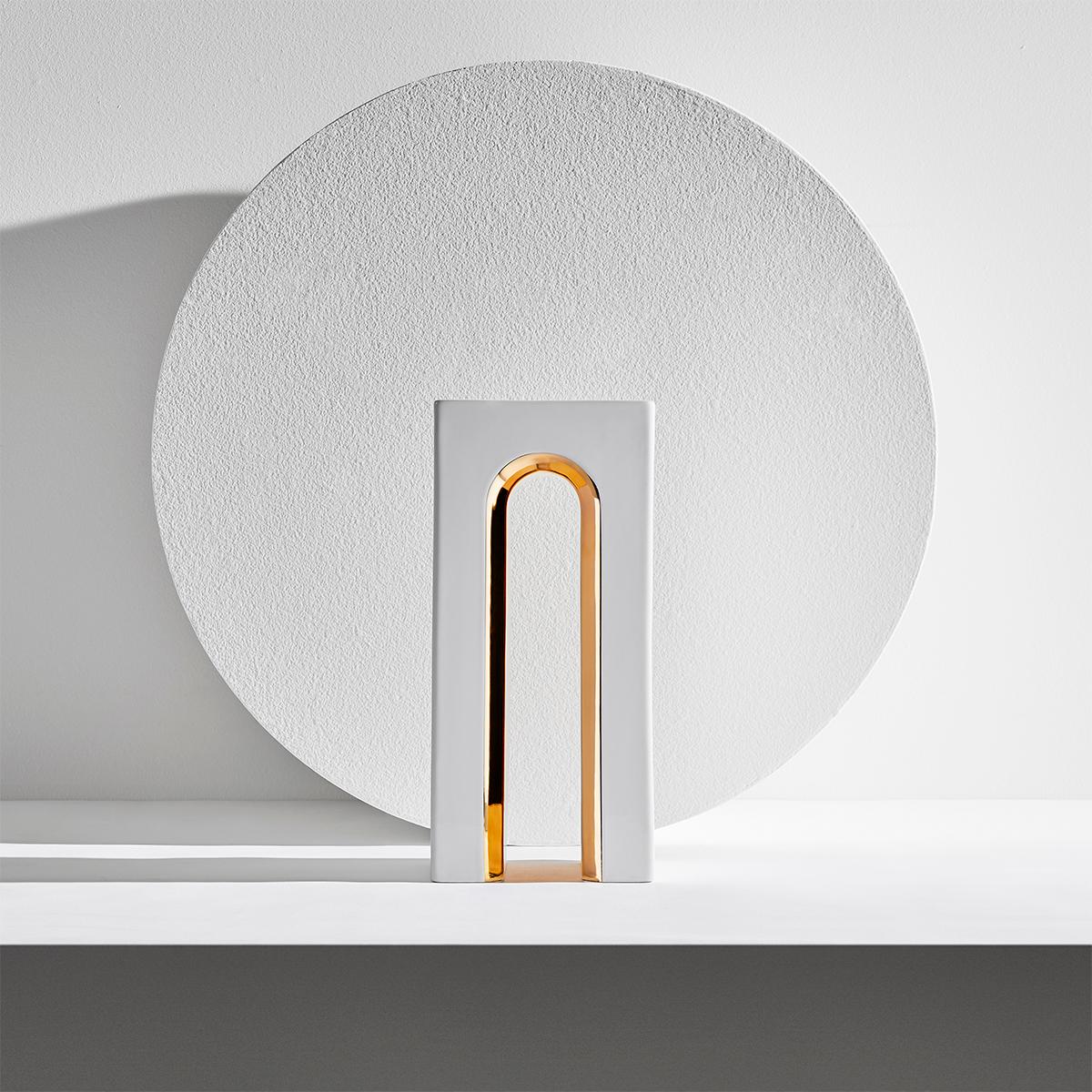 Marcello flower vase by LATOxLATO is inspired by the classical Italian architectural elegance and it is made of white ceramic with luxurious details in 24-karat gold that highlight its tall arch shape. Its sophisticated silhouette can be