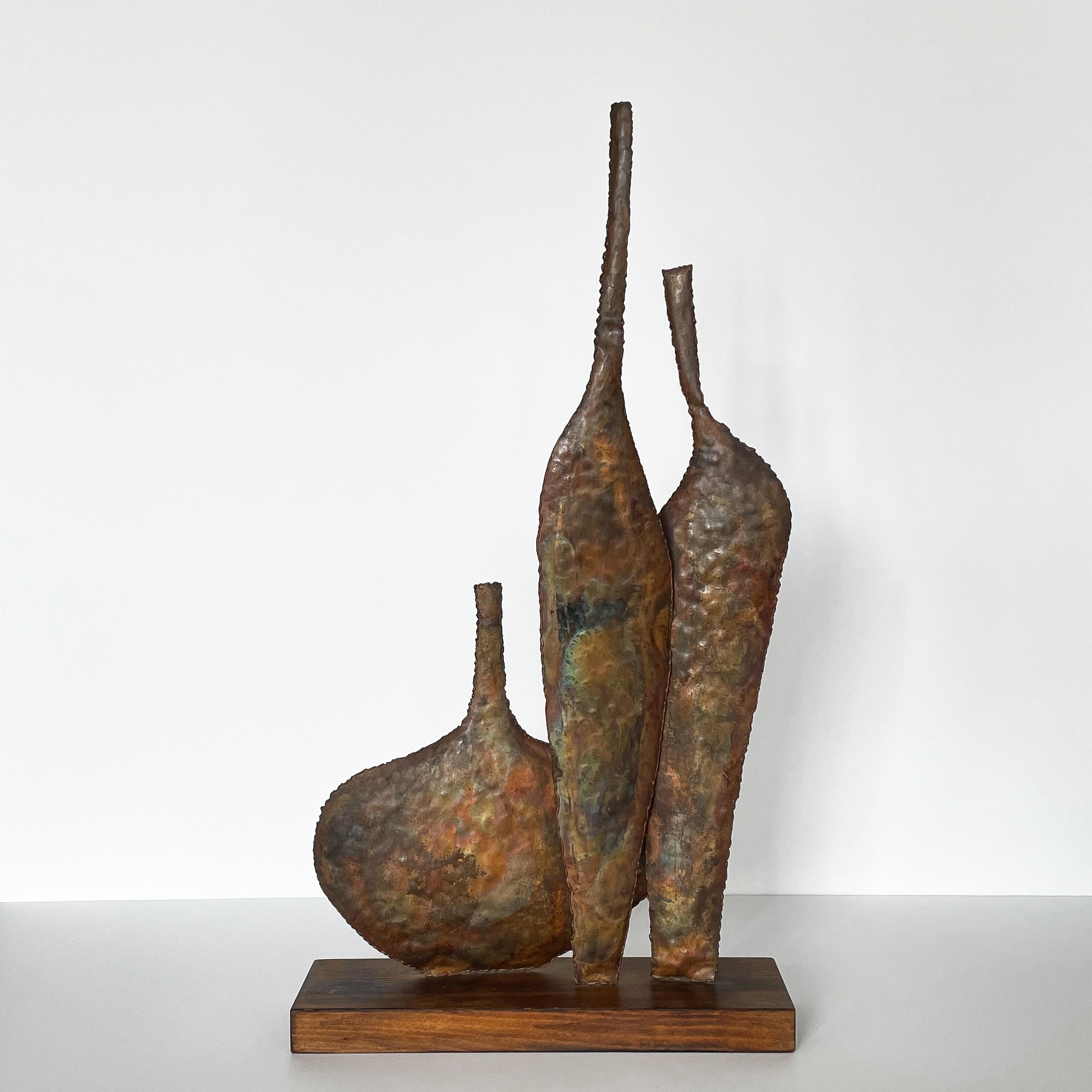 Mid century Brutalist copper bottle sculpture by Marcello Fantoni for Raymor, circa 1950s. Hand-wrought copper sculpture by Marcello Fantoni. Three varying sized abstract bottles on a wooden stand. Marked on wooden base 