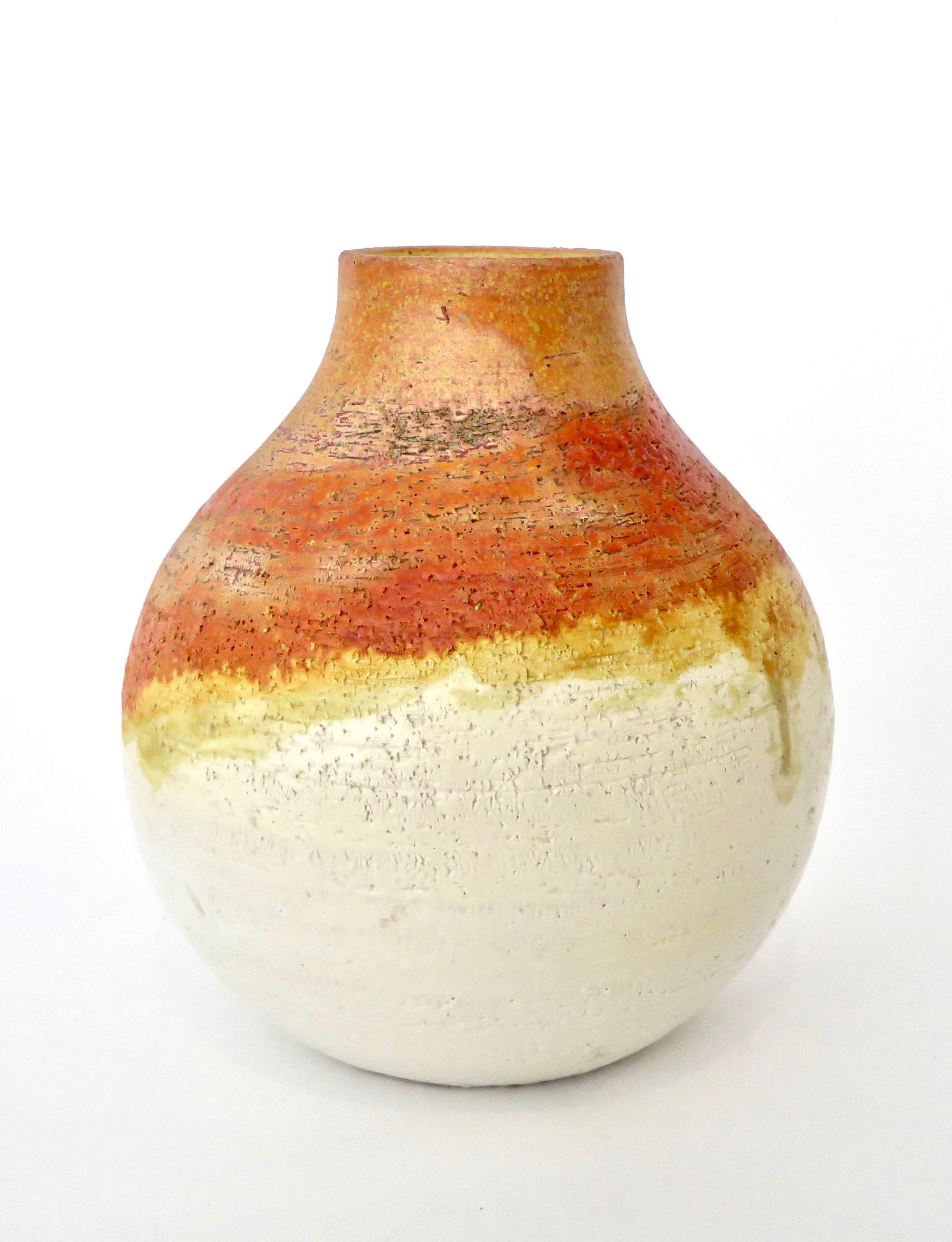 Marcello Fantoni ceramic vessel vase. Signed on bottom Fantoni, Italy.
A generous rounded form with a beautiful orange breaking to yellow and white glaze descending from the neck to white at the bottom.
Please look at the entire collection in the