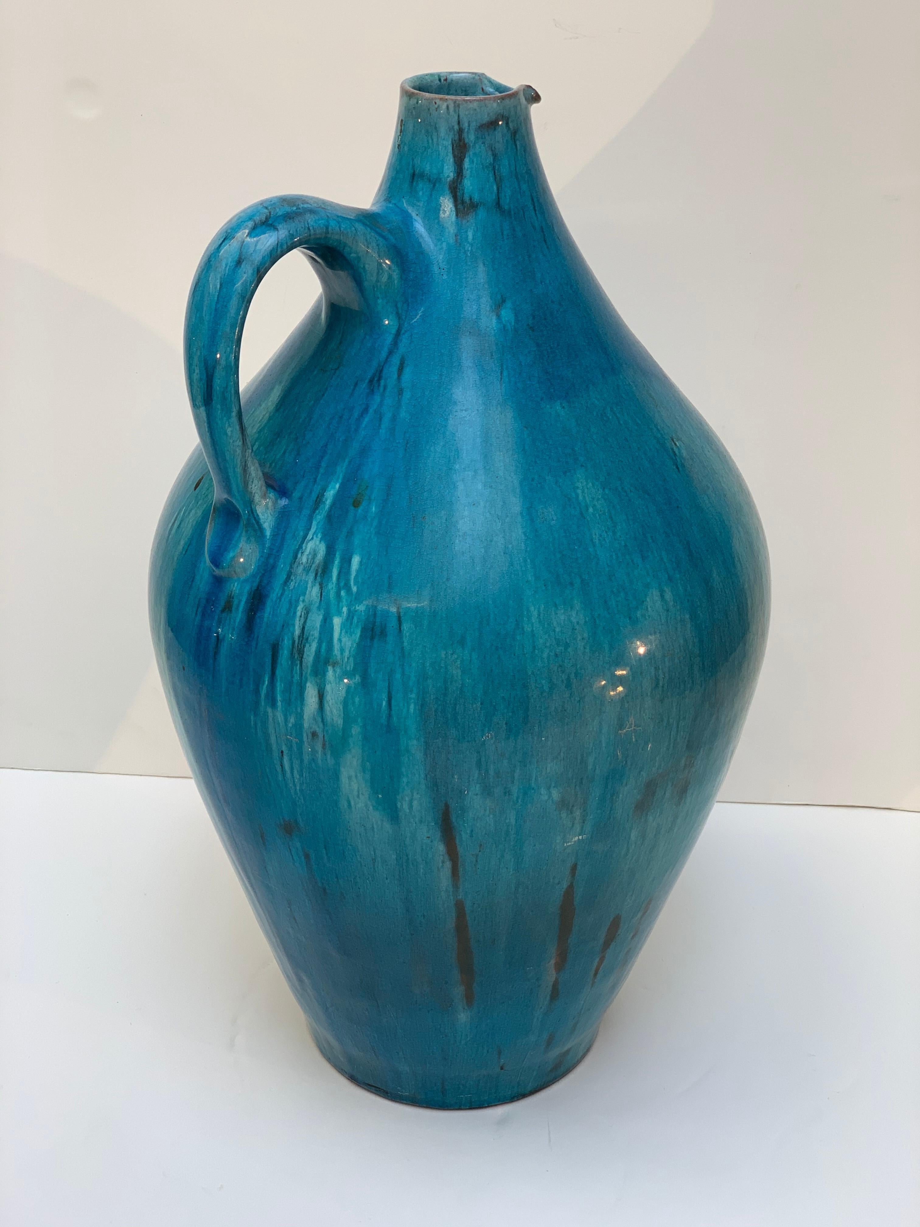 Midcentury vase in the shape of a jug with handle, beautiful color and enamel with light dripping, made by the master ceramist Marcello Fantoni in Florence Italy in the 1950s.
Signed Fantoni Italy under the base.
  