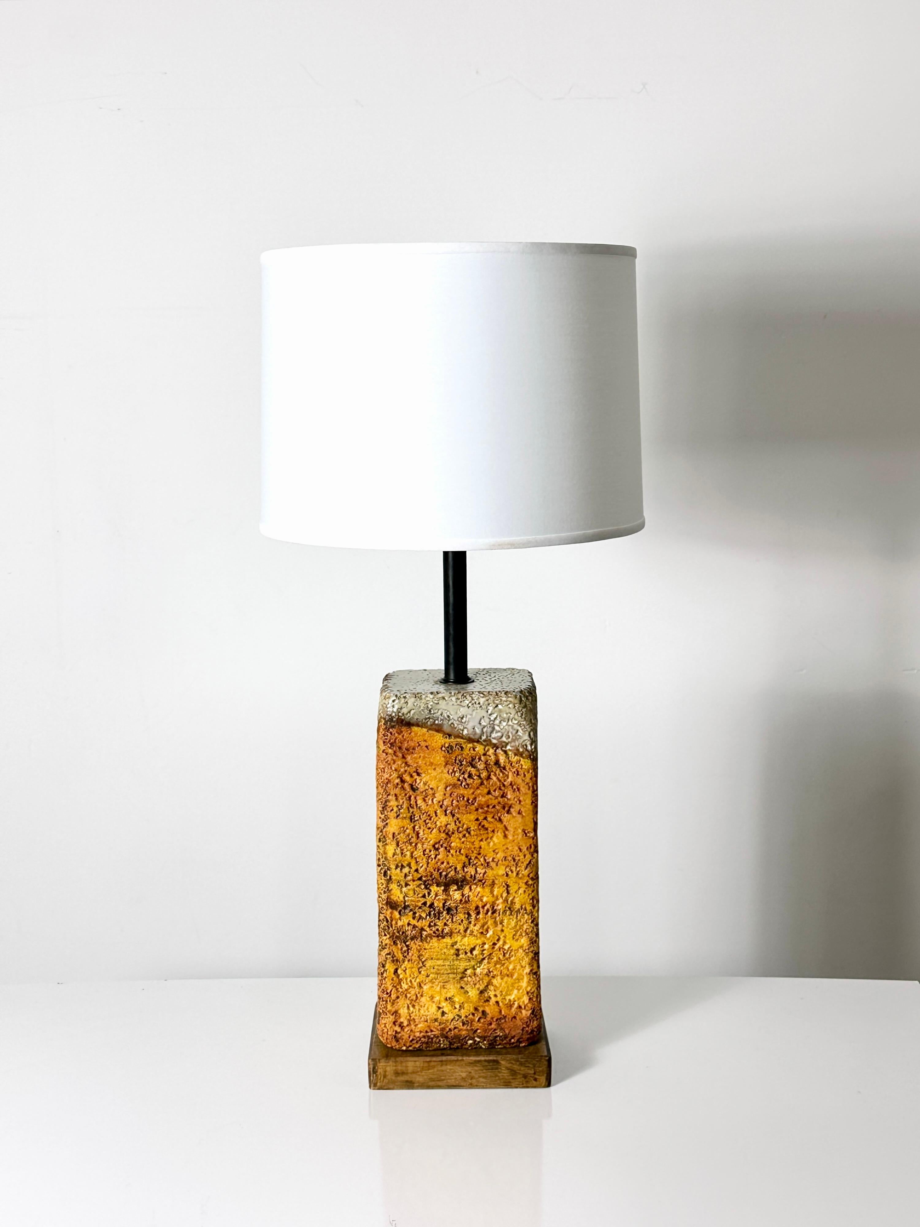 Lava glaze ceramic table lamp designed by Marcello Fantoni for Raymor circa 1950s
Textured base in muted orange and brown glazes
Mounted to original wood base
Three way socket
Shade is for display purposes and not included