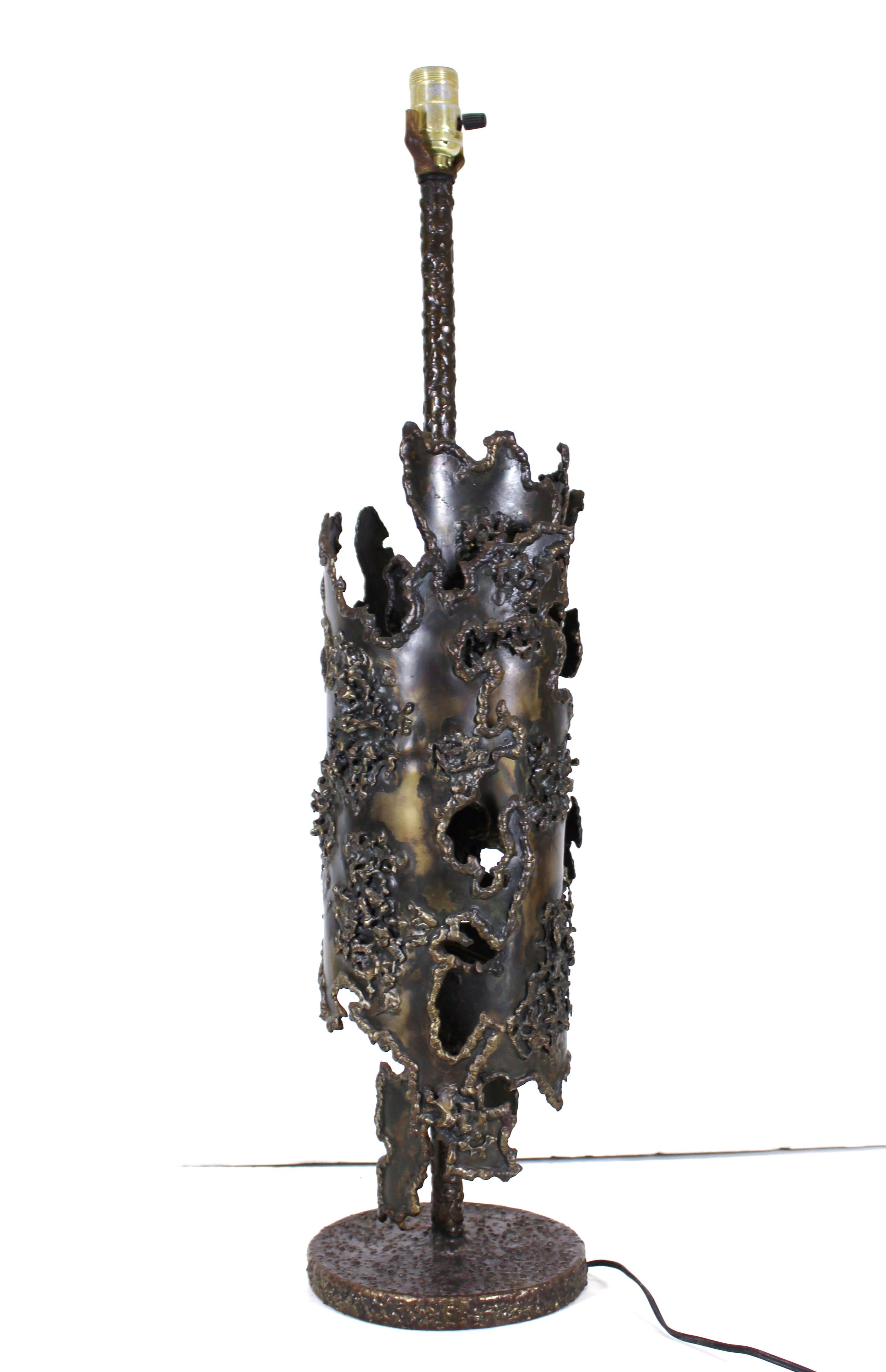 Italian early Brutalist torched wrought bronze and iron table lamp created by Marcello Fantoni. The piece was made during the 1970s and has a substantial weight to it. 