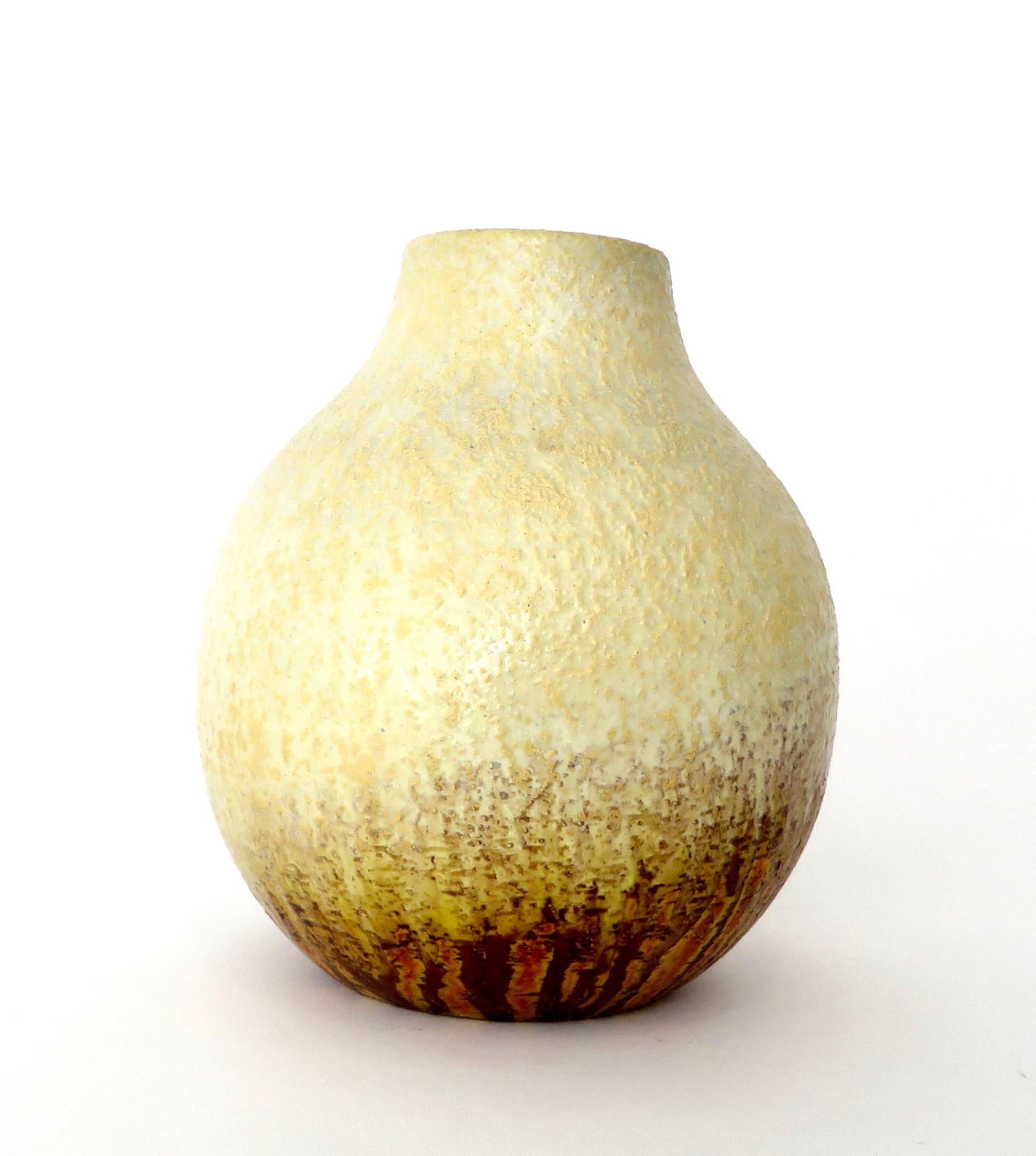 Marcello Fantoni ceramic vessel vase. Signed on bottom Fantoni, Italy for Raymor with original label. 
A generous rounded form with a beautiful pale white glaze with golden yellow, brown, and oranges. 
 