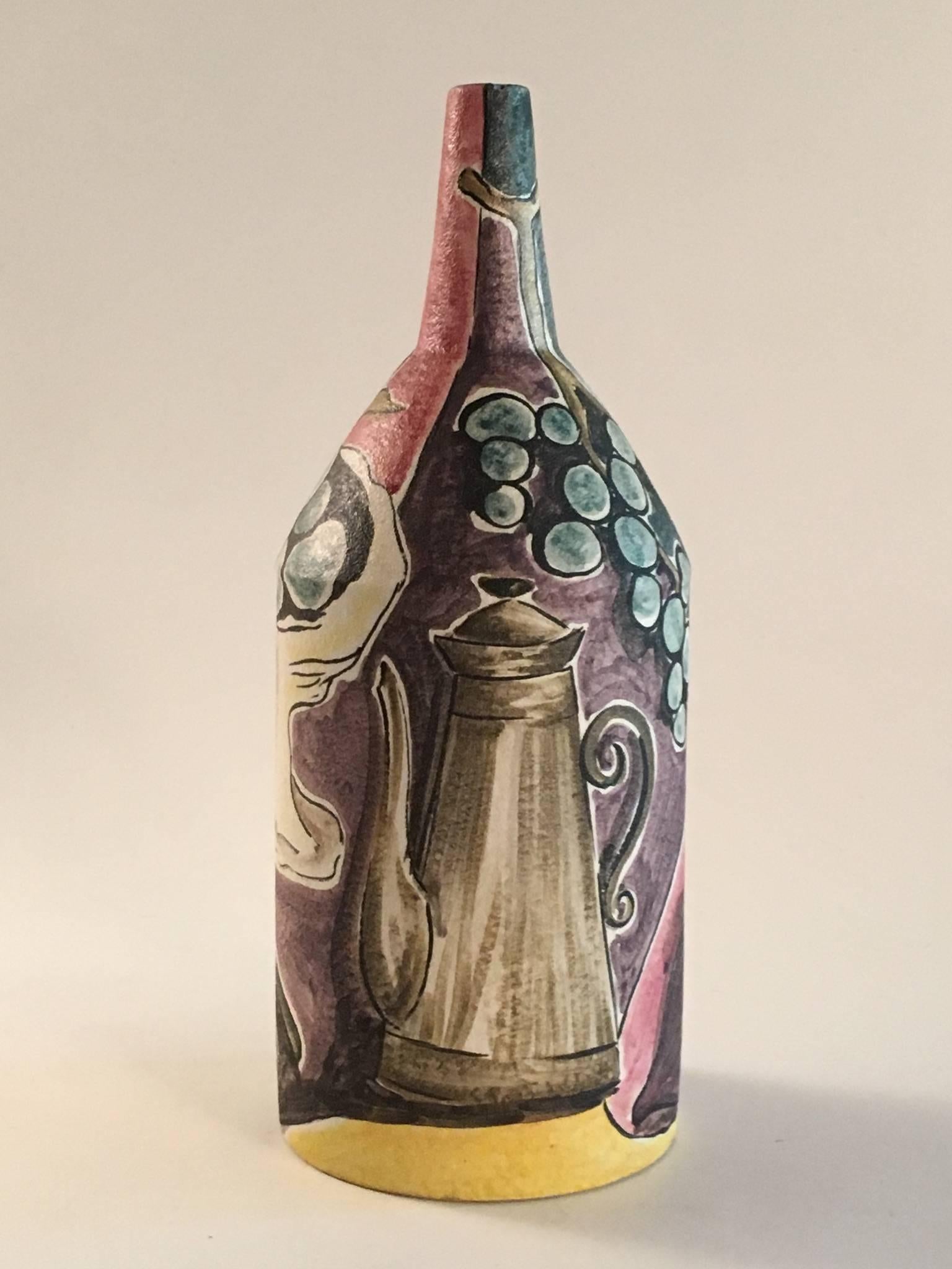 A beautiful and unusual large bottle shaped vase by the Italian master potter Marcello Fantoni. Decorated with a continuous still life table top setting with coffee pot, bowl of grapes, wine bottle and fruit. Finished in a matt glaze the vase and
