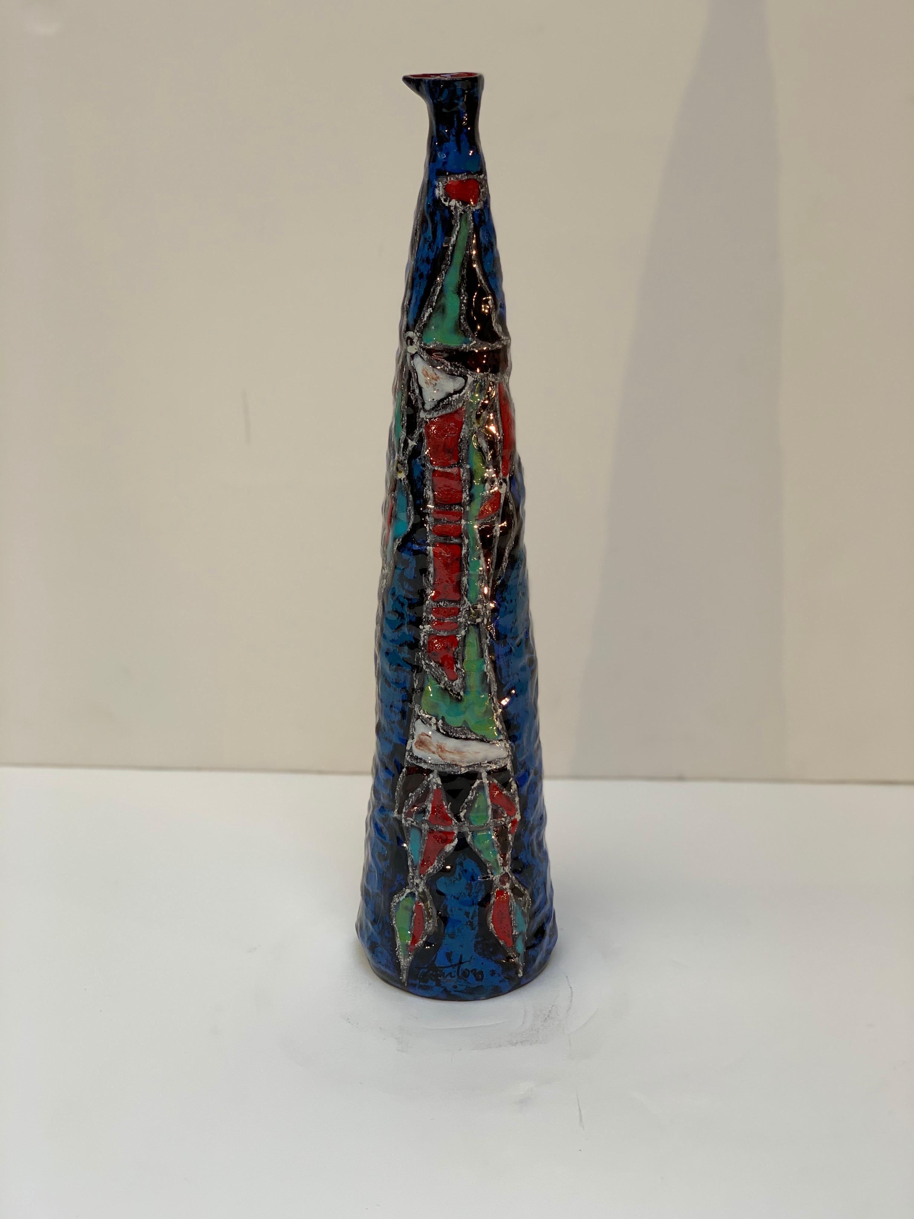 Rare ceramic vase by the master ceramist Marcello Fantoni Florence Italy circa 1956, beautiful blue background with decoration representing a multicolored warrior.
Asymmetric mouth with red interior.
Typical of the midcentury is the form and