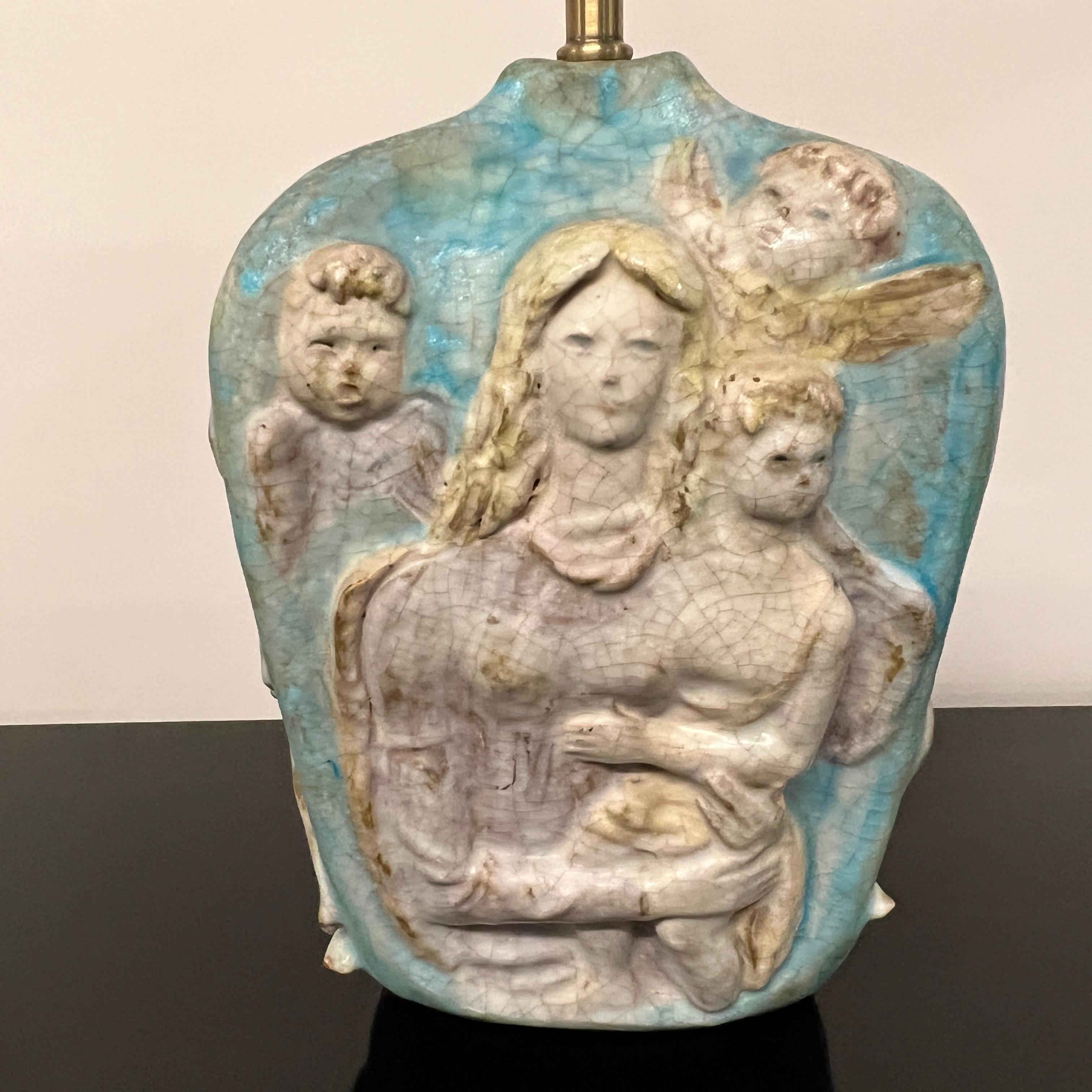 A beautiful and very early table lamp, with a classical figural imagery that features a mother and child along with angels, by Marcello Fantoni, “the Italian master of beauty.” It embodies the tension, typical of Fantoni’s work, between the dual