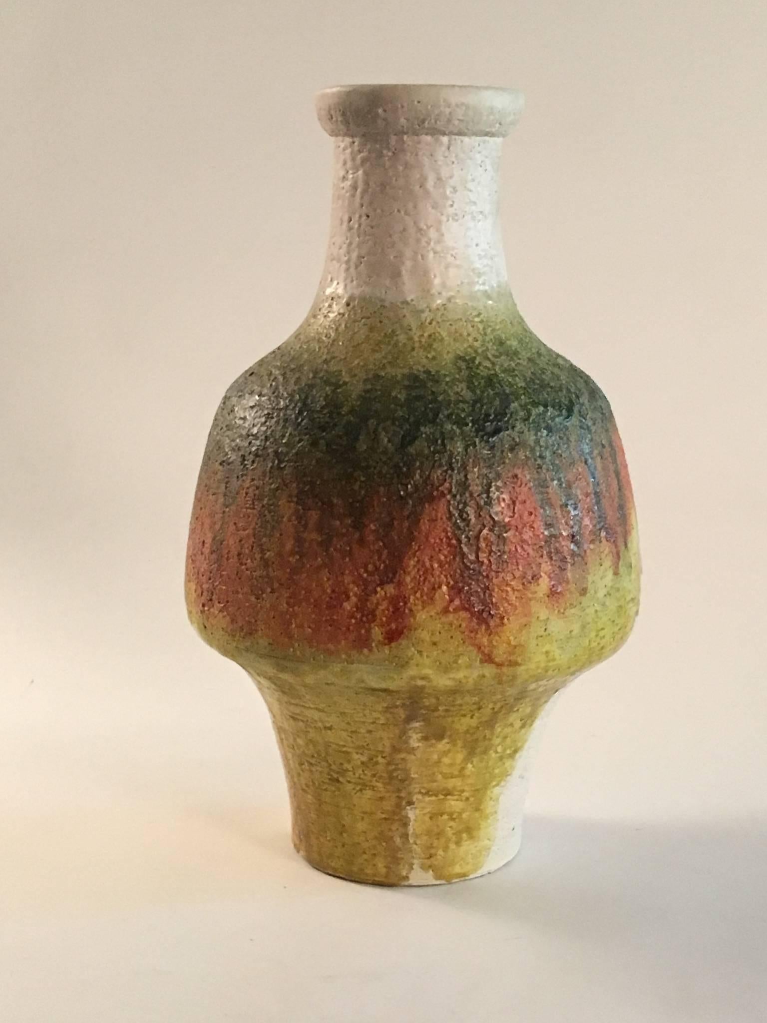 A lovely signed Marcello Fantoni waisted shape vase of large size. Decorated with dripping matt glazes of green, orange and yellow over a cream body. Signed underneath. Perfect condition.