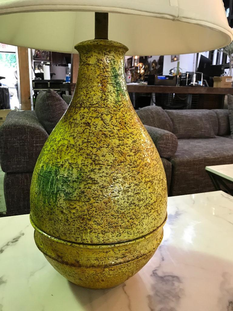 Beautifully designed and textured yellow green glazed studio ceramic lamp by Italian ceramics master or designer Marcello Fantoni for Raymor. Very rare and hard to find style and color. Would be stunning in any setting.

Signed on the