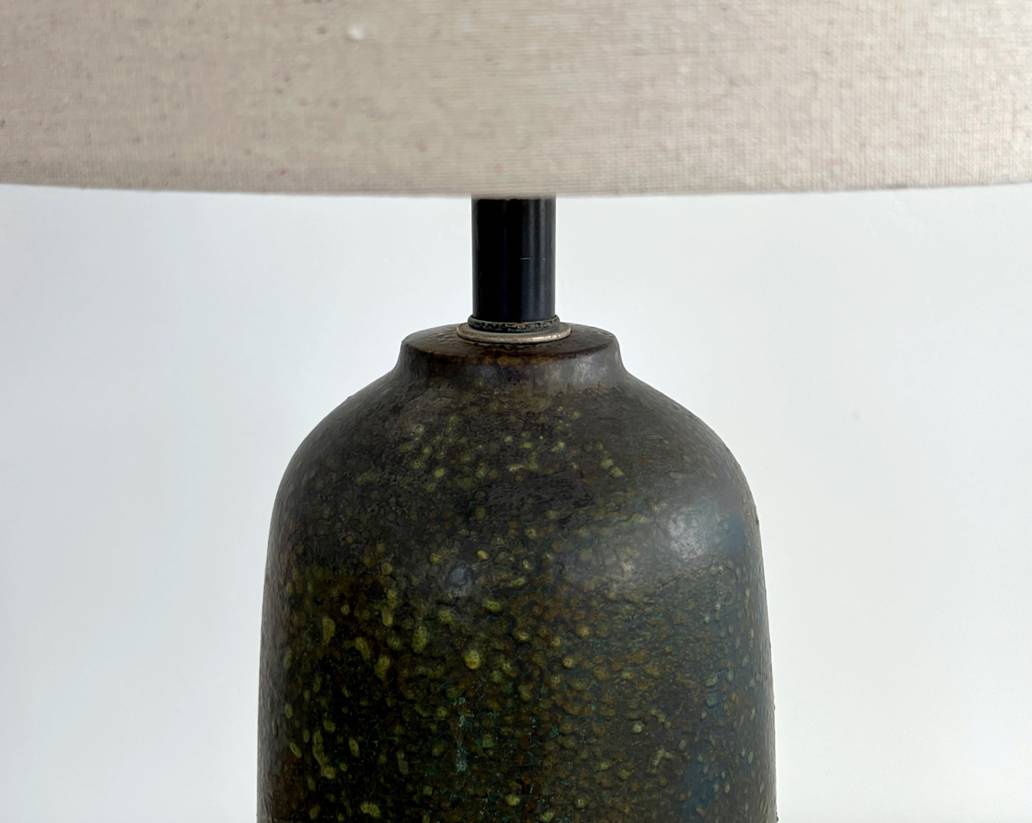 Unique lava glaze Marcello Fantoni Lamp, Ceramic, Brown and Green, Earth Tones. Large hand thrown studio ceramic lamp with a patinated wood base.  This lamp is large in scale and very interesting in color. There are deep greens, blues, browns, and
